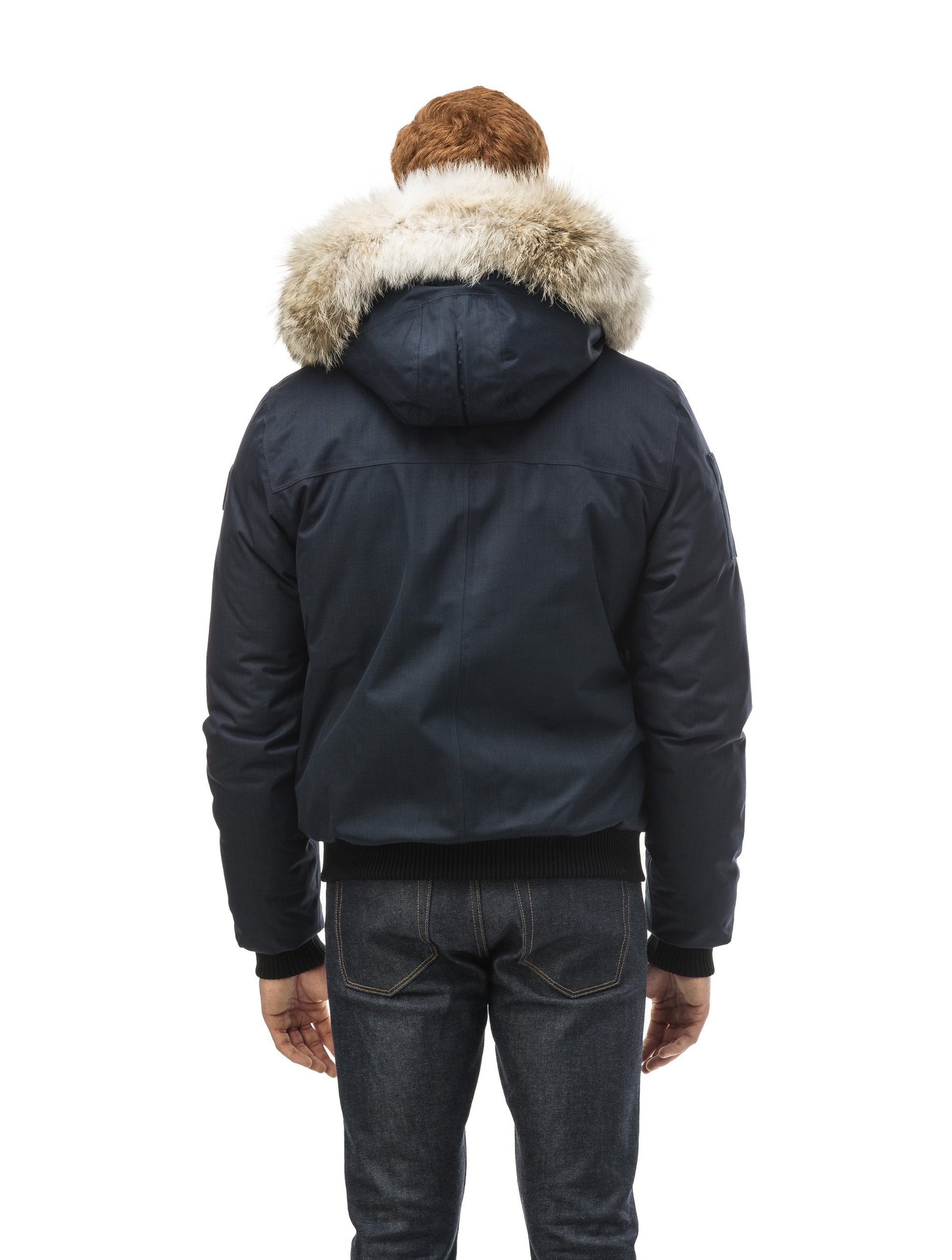 Men's classic down filled bomber jacket with a down filled hood that features a removable coyote fur trim and concealed moldable framing wire in Navy