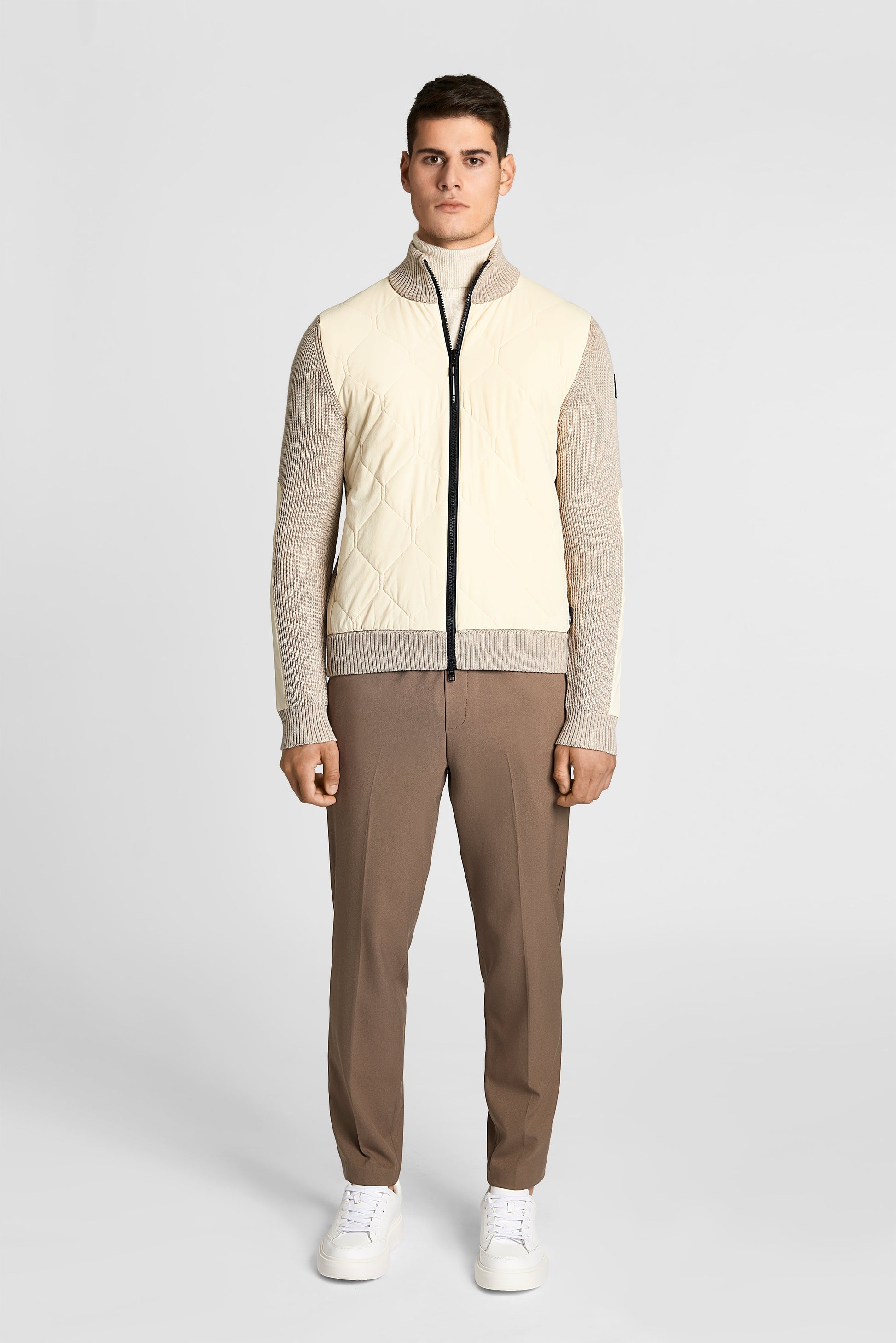 Ero Men's Tailored Hybrid Sweater in hip length, PrimaLoft Gold Insulation Active+, Durable 4-Way Stretch Weave quilted torso, Merino wool knit collar, sleeves, back, and cuffs, two-way front zipper, and hidden waist pockets, in Wheat