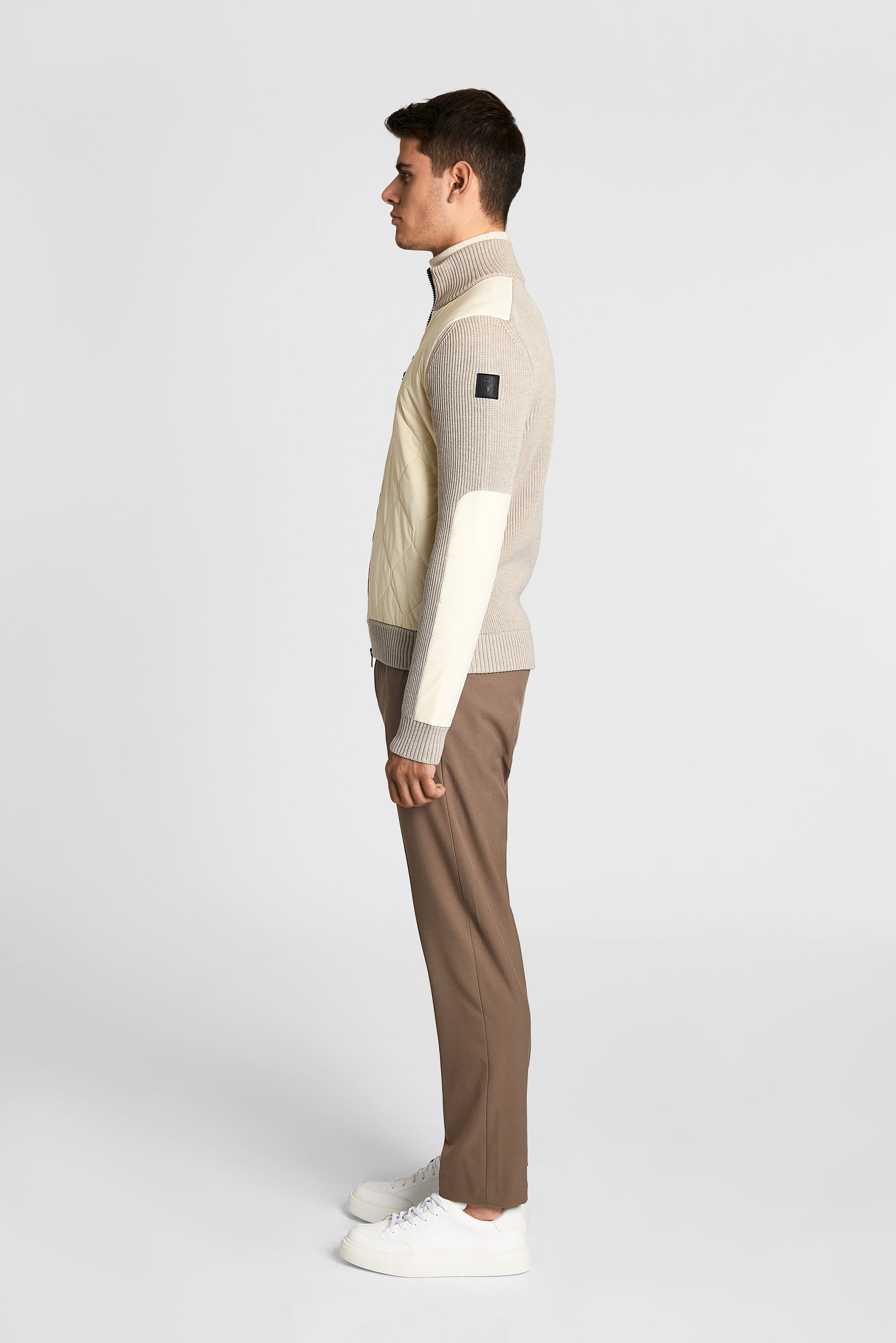 Ero Men's Tailored Hybrid Sweater in hip length, PrimaLoft Gold Insulation Active+, Durable 4-Way Stretch Weave quilted torso, Merino wool knit collar, sleeves, back, and cuffs, two-way front zipper, and hidden waist pockets, in Wheat