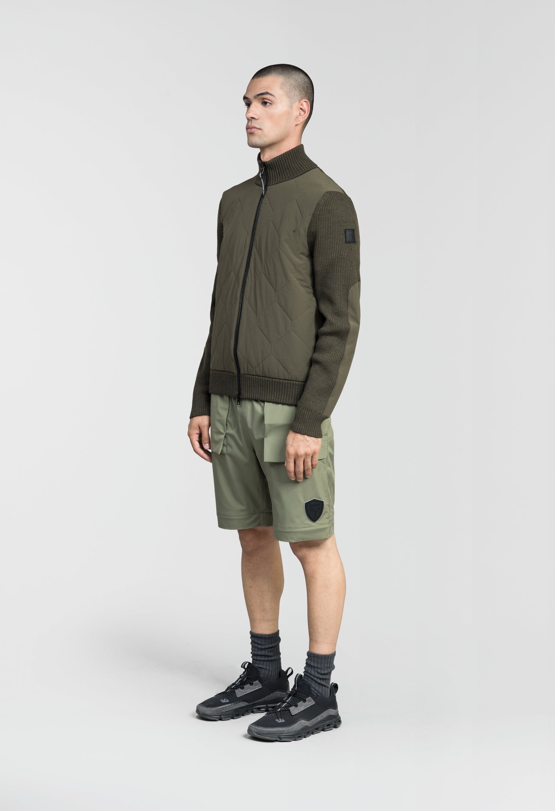 Ero Men's Tailored Hybrid Sweater in hip length, PrimaLoft Gold Insulation Active+, Durable 4-Way Stretch Weave quilted torso, Merino wool knit collar, sleeves, back, and cuffs, two-way front zipper, and hidden waist pockets, in Fatigue