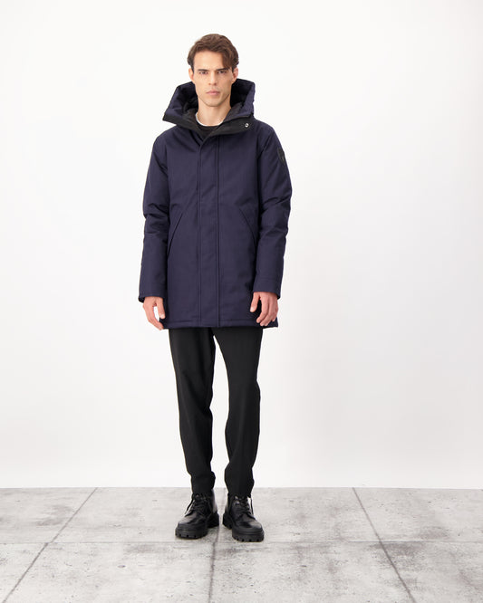 Pierre Men's Jacket in thigh length, Canadian white duck down insulation, non-removable down-filled hood, angled waist pockets, centre-front zipper with wind flap, and elastic ribbed cuffs, in CH Navy