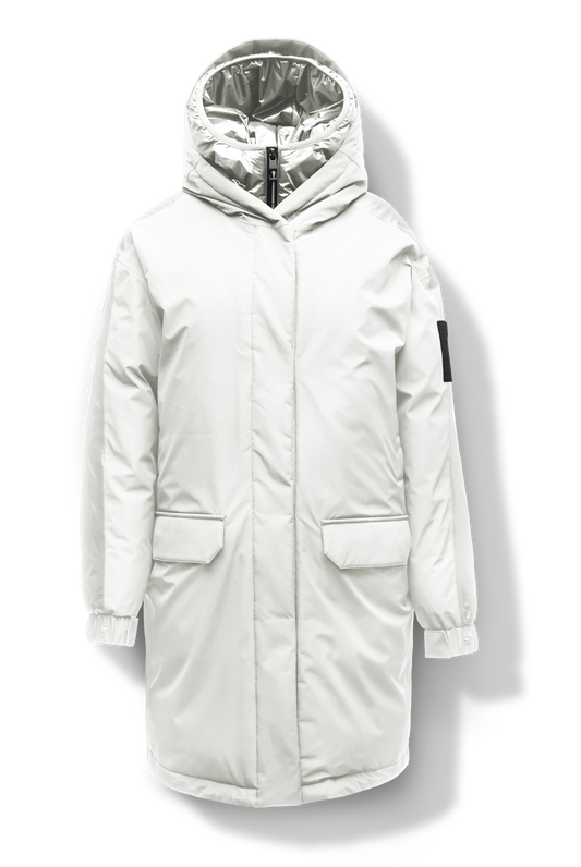 Slyn Women's Performance Parka in thigh length, premium 3-ply micro denier and cire technical nylon taffeta fabrication, Premium Canadian origin White Duck Down insulation, non-removable down-filled hood, inner hooded gilet, two-way centre-front zipper with magnetic closure wind flap, fleece-lined pockets at chest and waist, pit zipper vents, in Chalk + Chalk