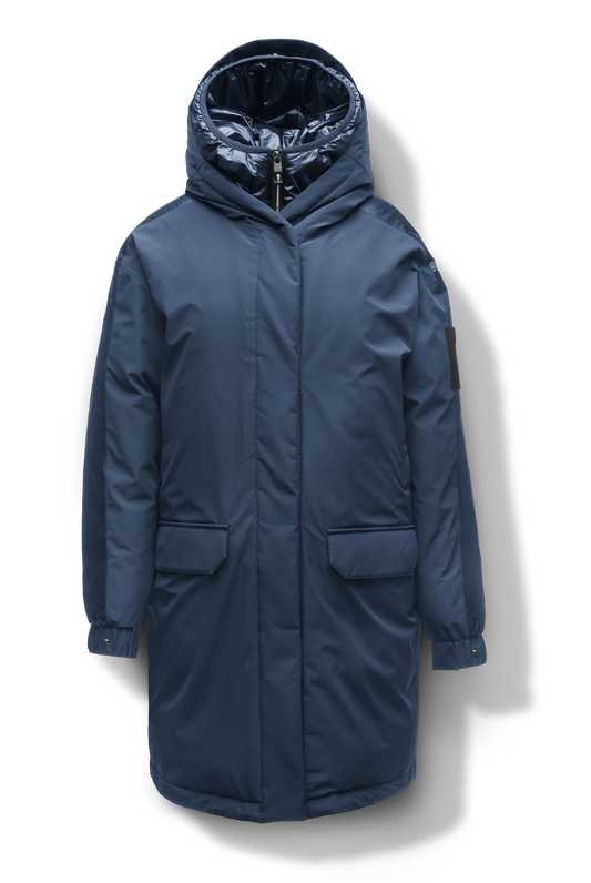 Slyn Women's Performance Parka in thigh length, premium 3-ply micro denier and cire technical nylon taffeta fabrication, Premium Canadian origin White Duck Down insulation, non-removable down-filled hood, inner hooded gilet, two-way centre-front zipper with magnetic closure wind flap, fleece-lined pockets at chest and waist, pit zipper vents, in Marine + Marine