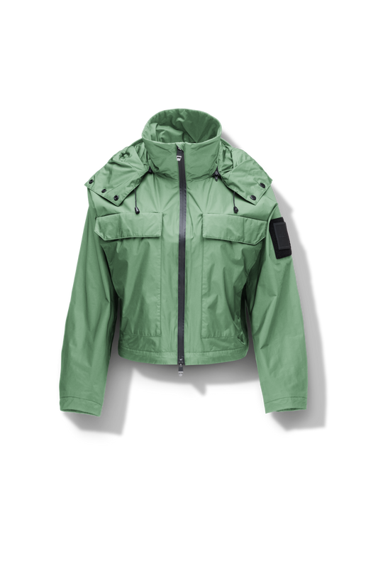 Viva Women's Performance Cropped Jacket in waist length, premium iridescent fabrication, removable hood with peak, adjustable hood draw cords and toggle, 2-way branded zipper at centre front, oversized magnetic closure flap pockets at chest with side entry, interior adjustable draw cord at hem, large interior zipper pocket, and adjustable snap cuffs, in Comfrey + Comfrey