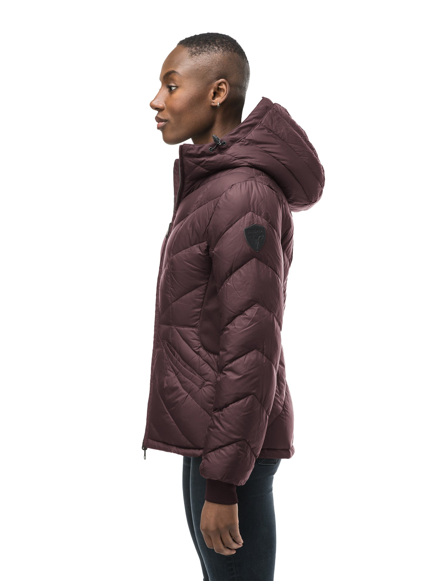 A women's two in one reversible hip length down jacket, one side is quilted and one side is solid waterproof fabric in Burgundy