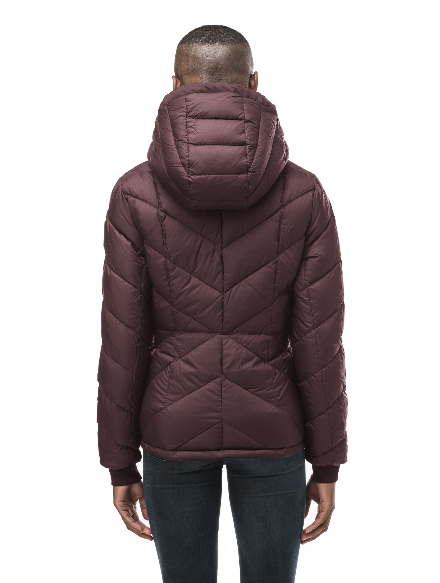 A women's two in one reversible hip length down jacket, one side is quilted and one side is solid waterproof fabric in Burgundy