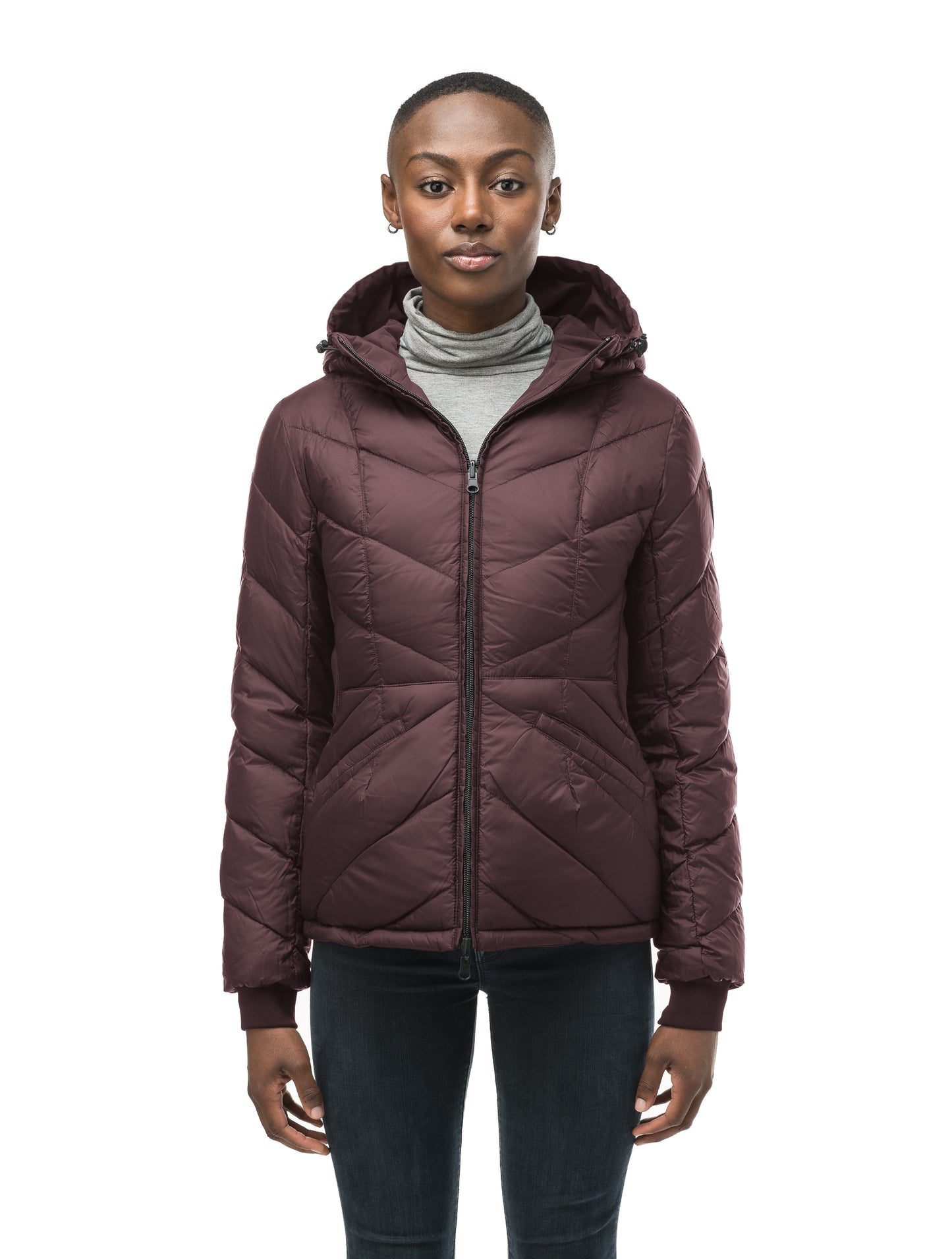 A women's two in one reversible hip length down jacket, one side is quilted and one side is solid waterproof fabric in Burgundy