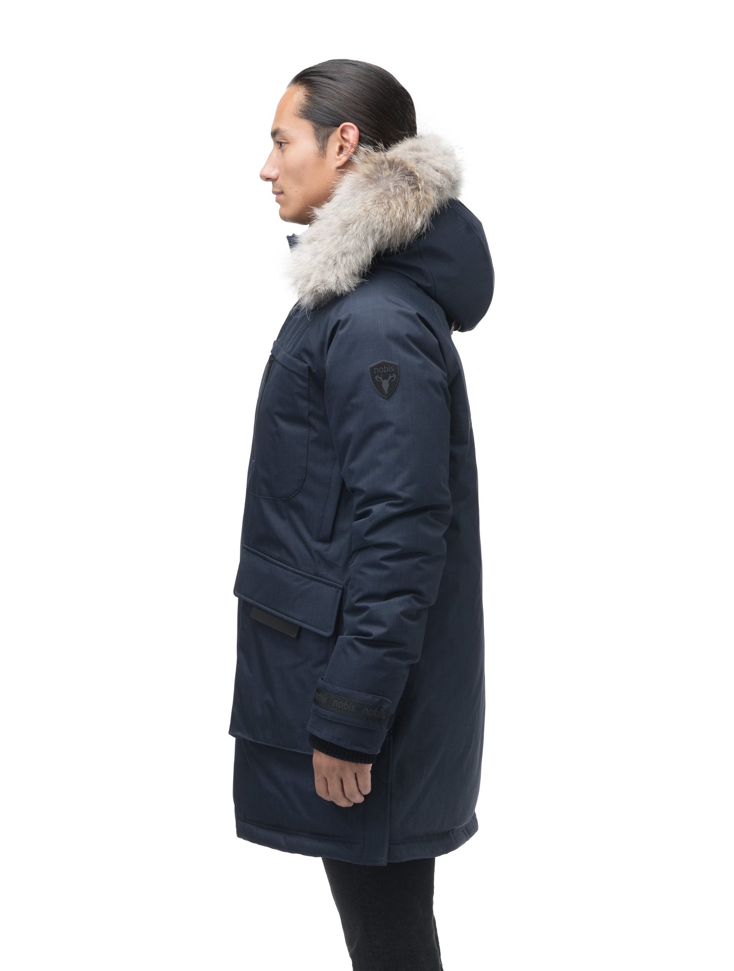 Men's thigh length down-filled parka with removable hood and removable coyote fur trim in Navy