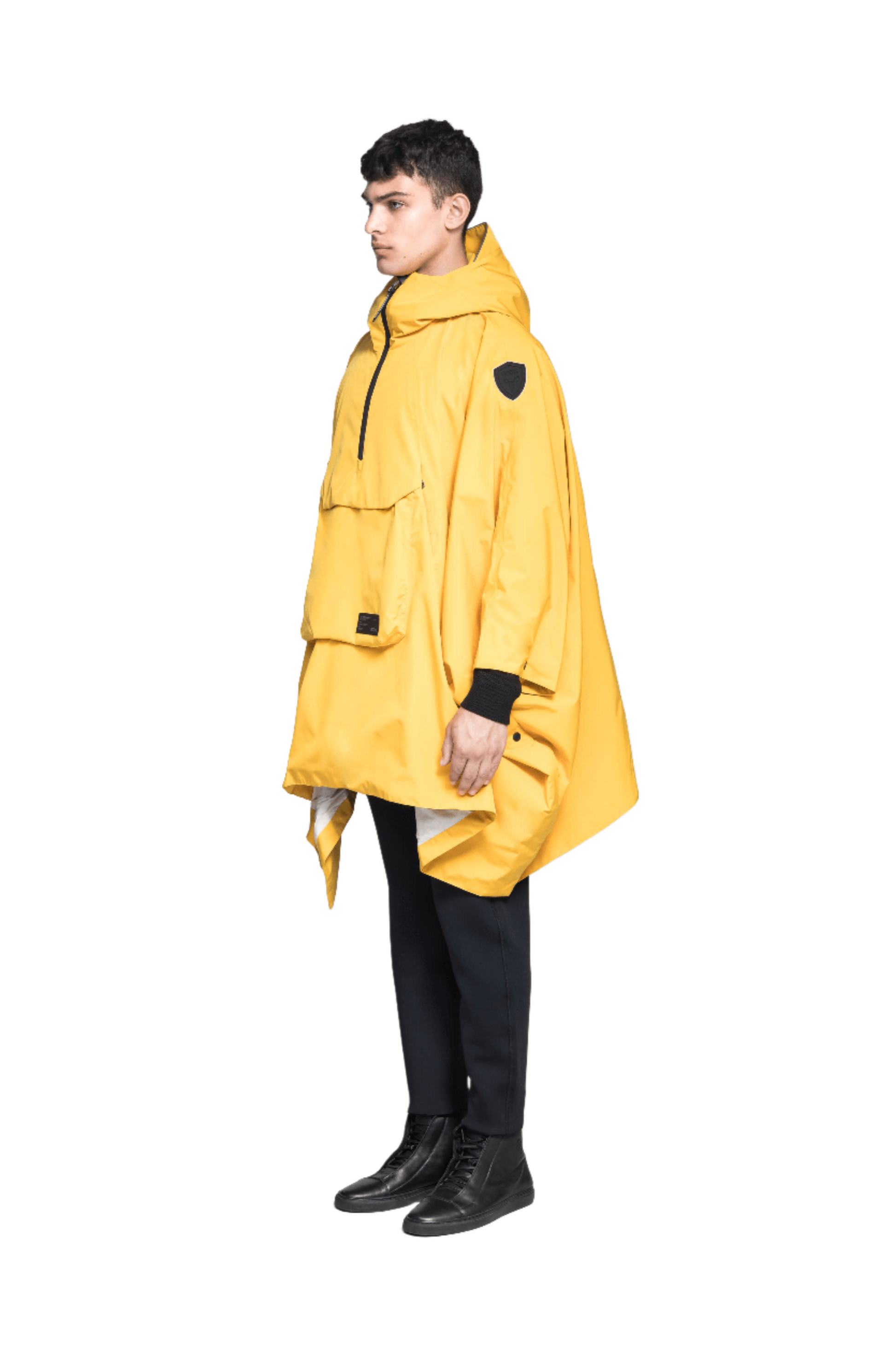 Hydra Unisex Performance Poncho in thigh length, non-removable hood, vertical half-zipper along centre front collar, hidden side-entry waist zipper pockets, adjustable webbing straps and snap closure cuffs, and packable to front kangaroo pocket with flap opening, in Old Gold