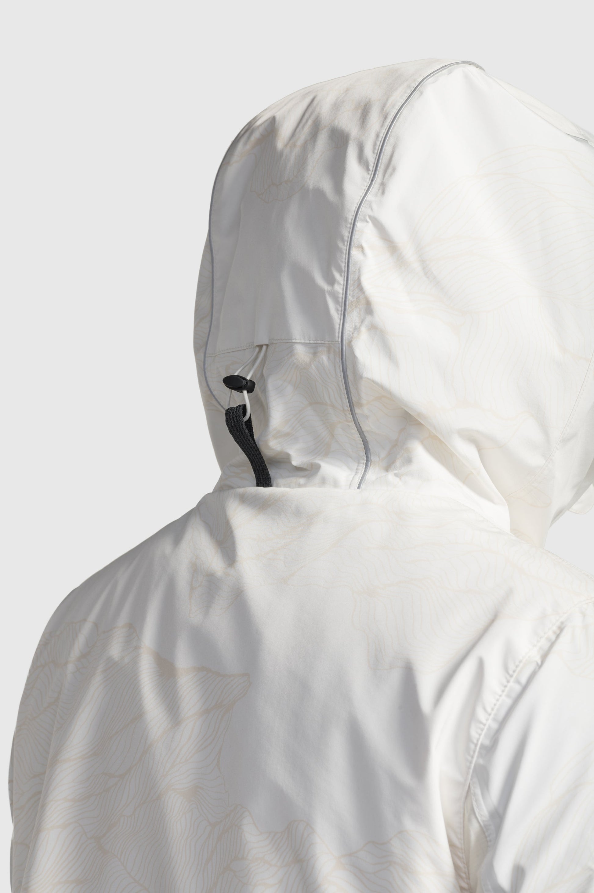 Alta Men's Performance Shell Jacket in hip length, Primaloft Gold Insulation Active+, chest and waist pockets, ventilation under arms, reflective detailing on hood and back, two-way front zipper, and non-removable hood with adjustable drawstrings, in Wheat Desert