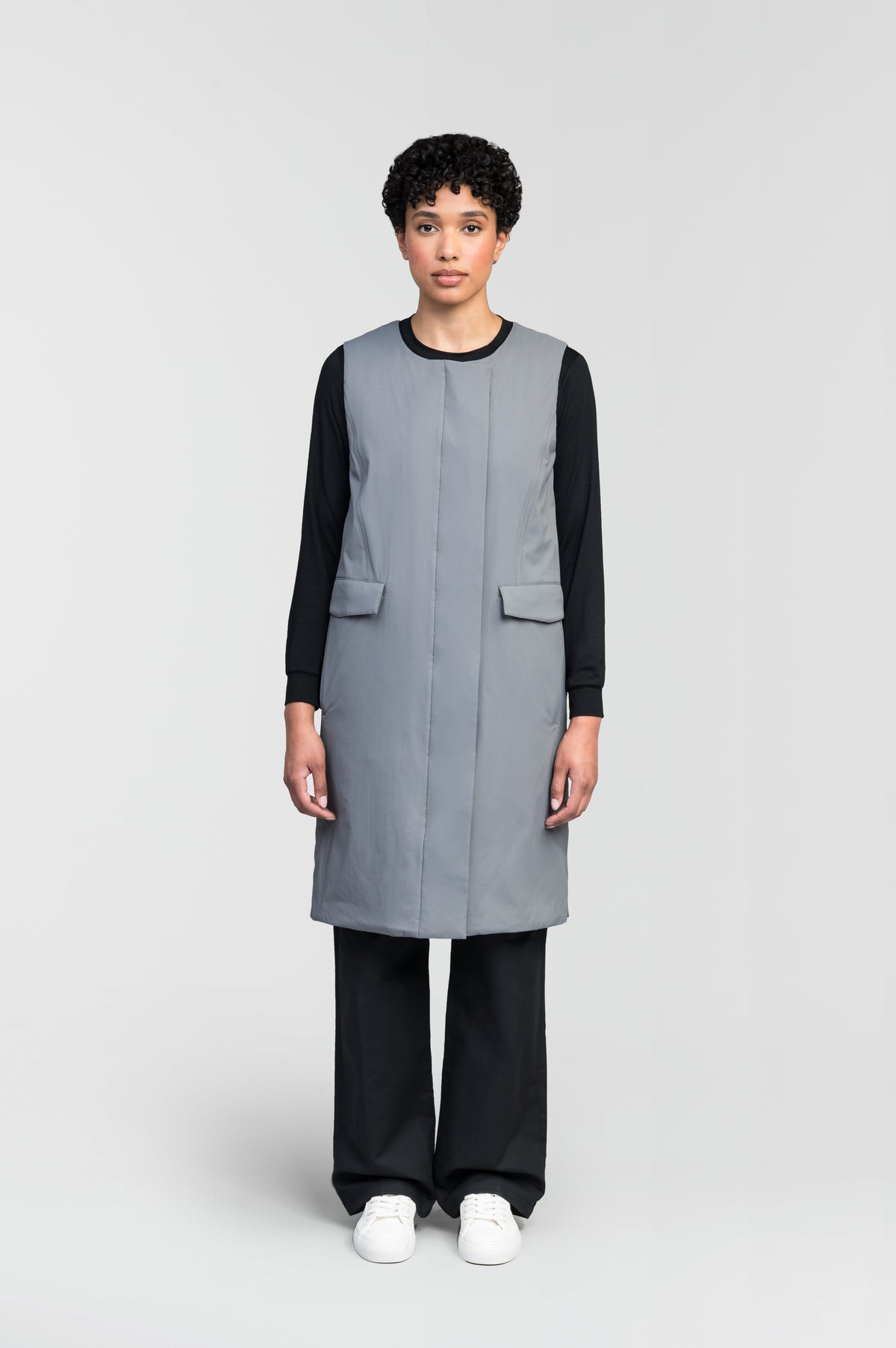 Brexton Women's Tailored Long Mid Layer Vest in knee length, centre front wind flap, flap closure waist pocket with additional side entry storage, single vent on back bottom hem, in Concrete