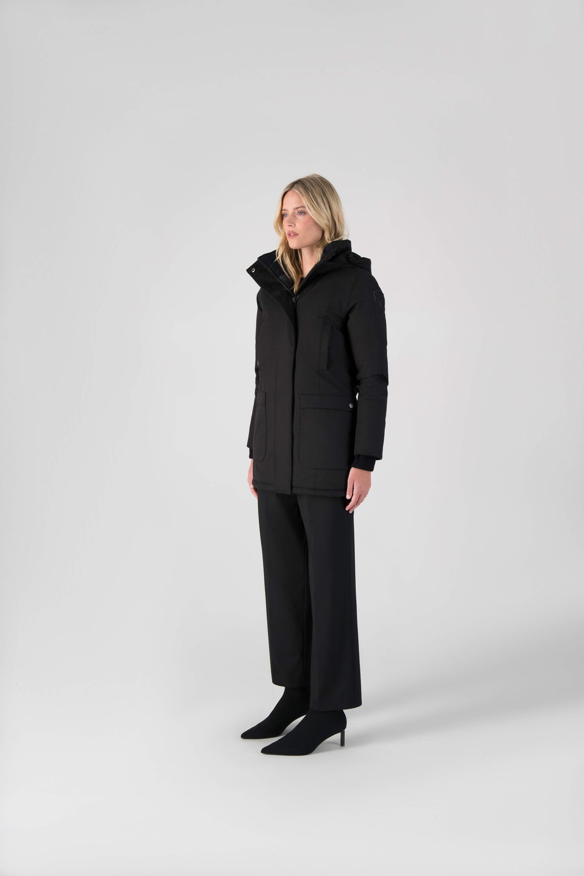 Women's down filled parka that sits just below the hip with a clean look and two hip patch pockets in Black