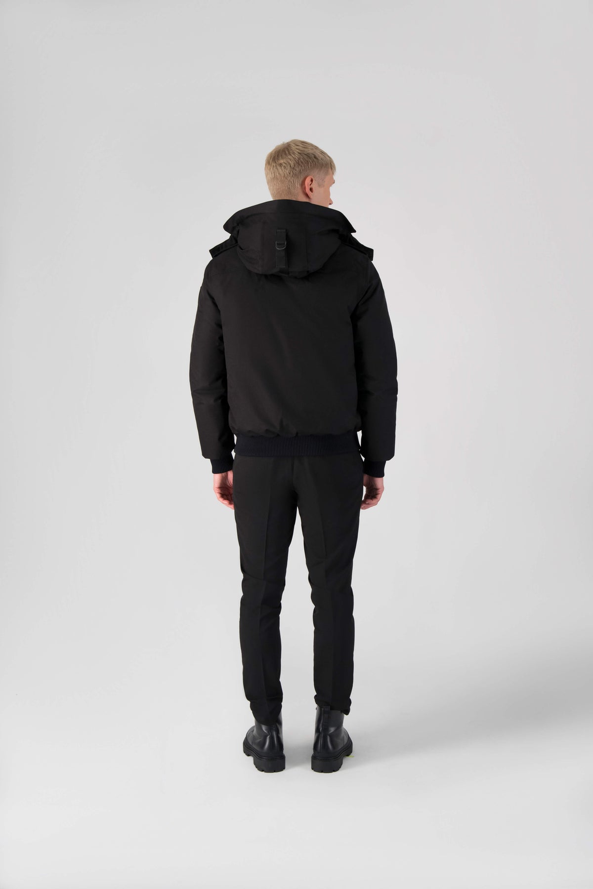 Men's down filled bomber that sits just above the hips with a completely removable hood that's windproof, waterproof, and breathable in Black