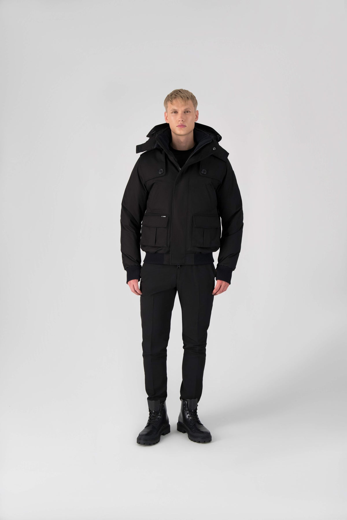 Men's down filled bomber that sits just above the hips with a completely removable hood that's windproof, waterproof, and breathable in Black