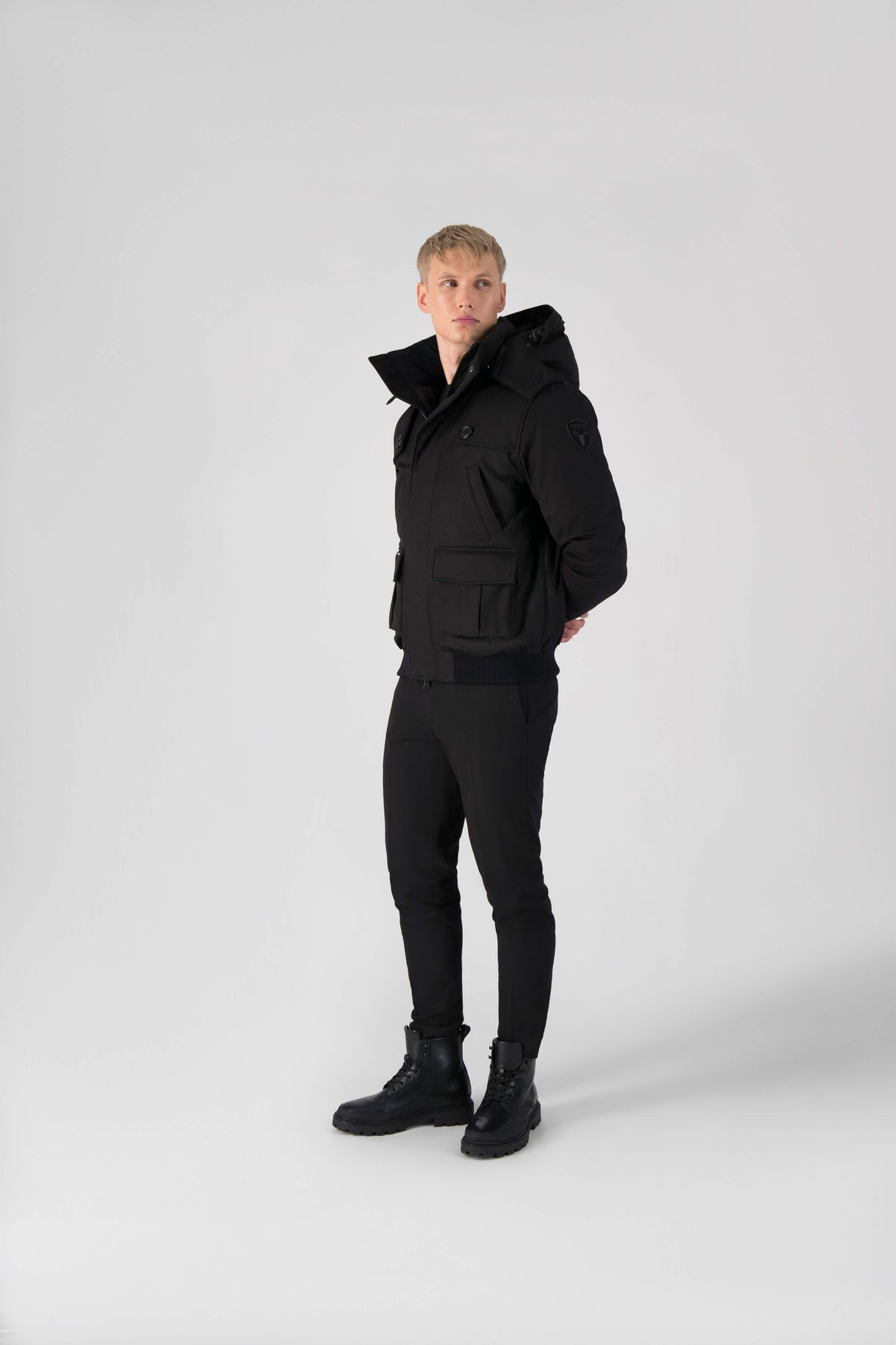 Men's down filled bomber that sits just above the hips with a completely removable hood that's windproof, waterproof, and breathable in Black