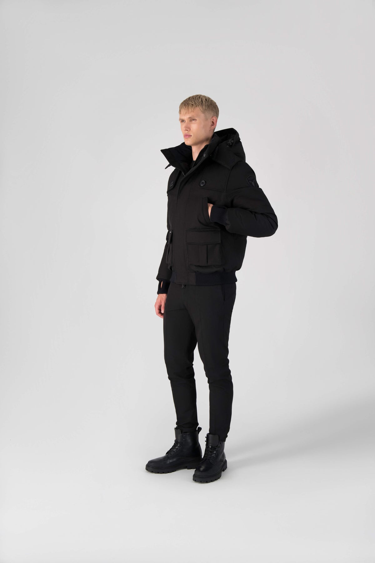 Men's down filled bomber that sits just above the hips with a completely removable hood that's windproof, waterproof, and breathable in Black