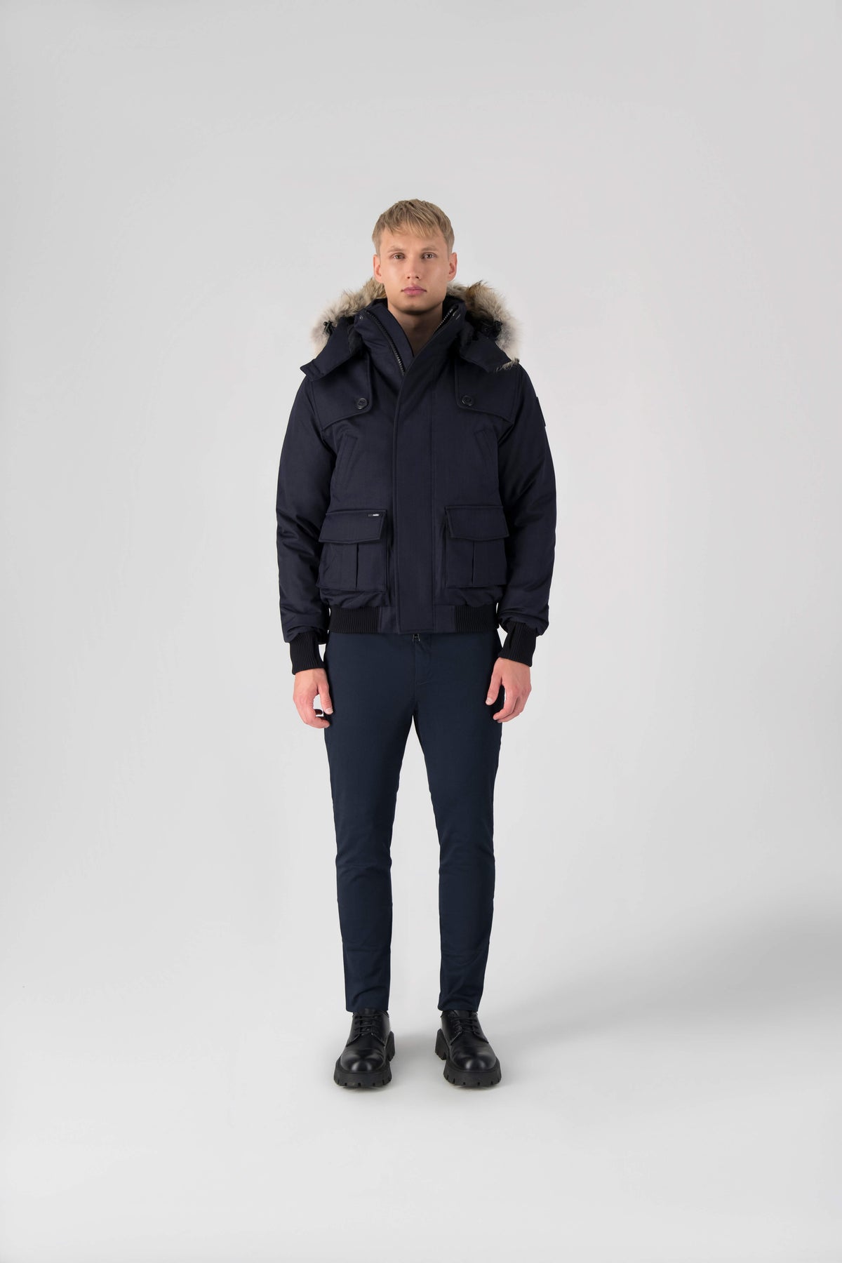 Men's down filled bomber that sits just above the hips with a completely removable hood that's windproof, waterproof, and breathable in Navy