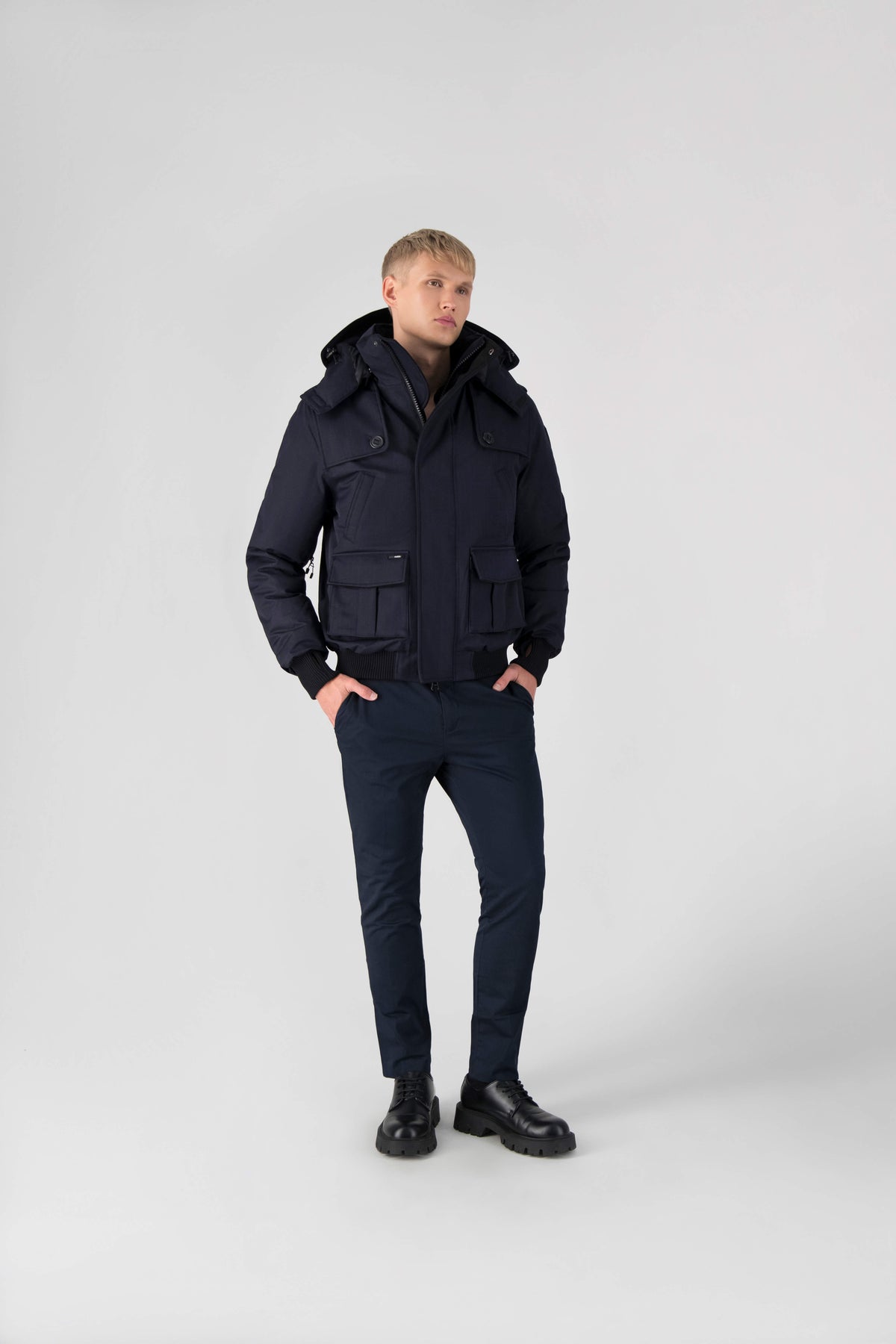 Men's down filled bomber that sits just above the hips with a completely removable hood that's windproof, waterproof, and breathable in Navy