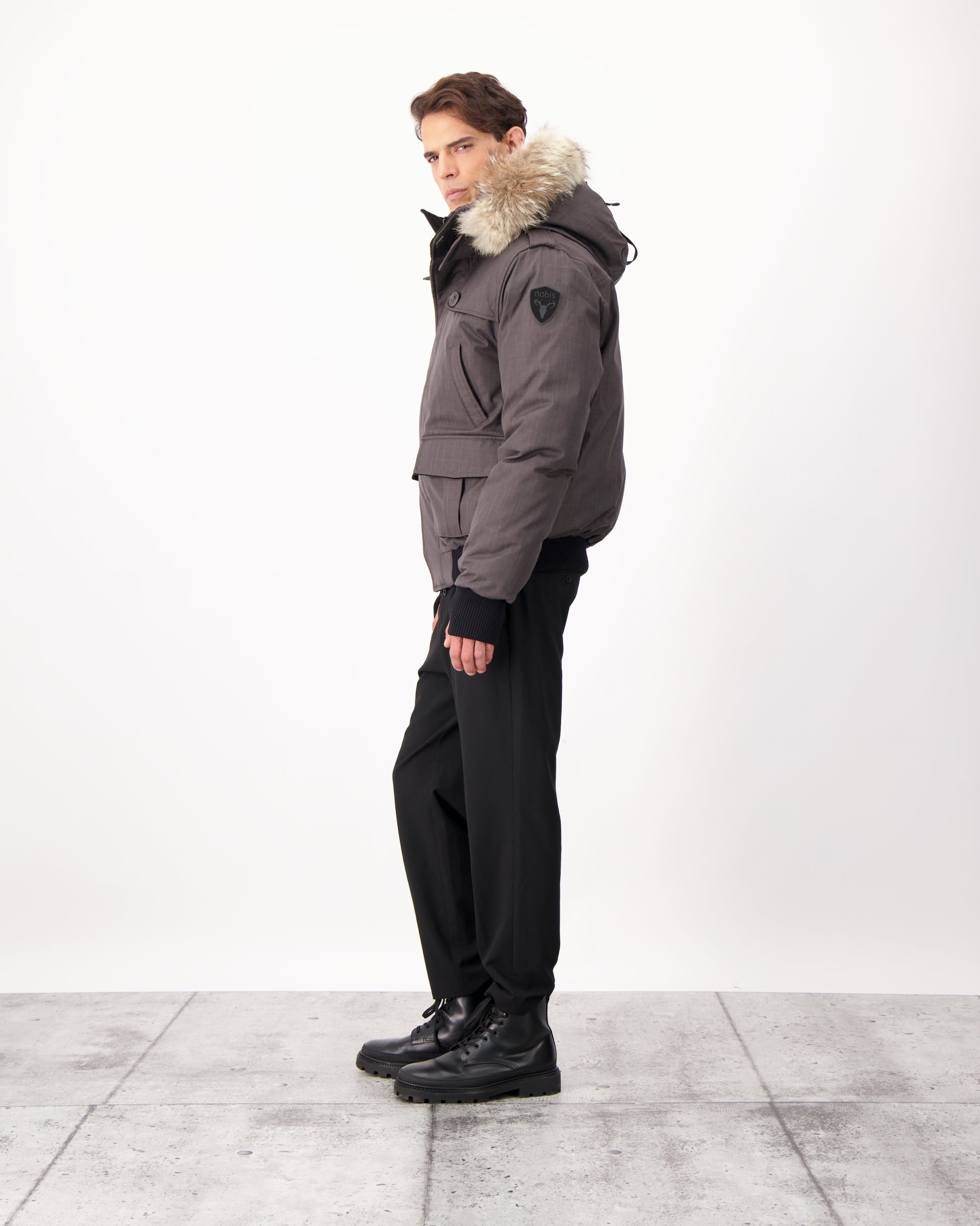 Men's down filled bomber that sits just above the hips with a completely removable hood that's windproof, waterproof, and breathable in CH Steel Grey