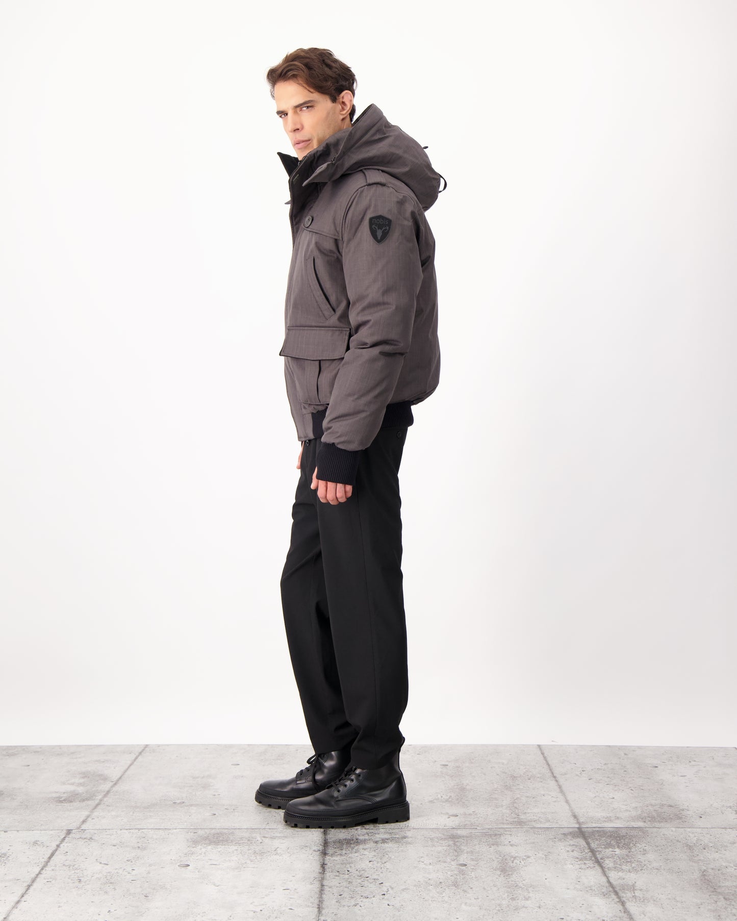Men's down filled bomber that sits just above the hips with a completely removable hood that's windproof, waterproof, and breathable in CH Steel Grey