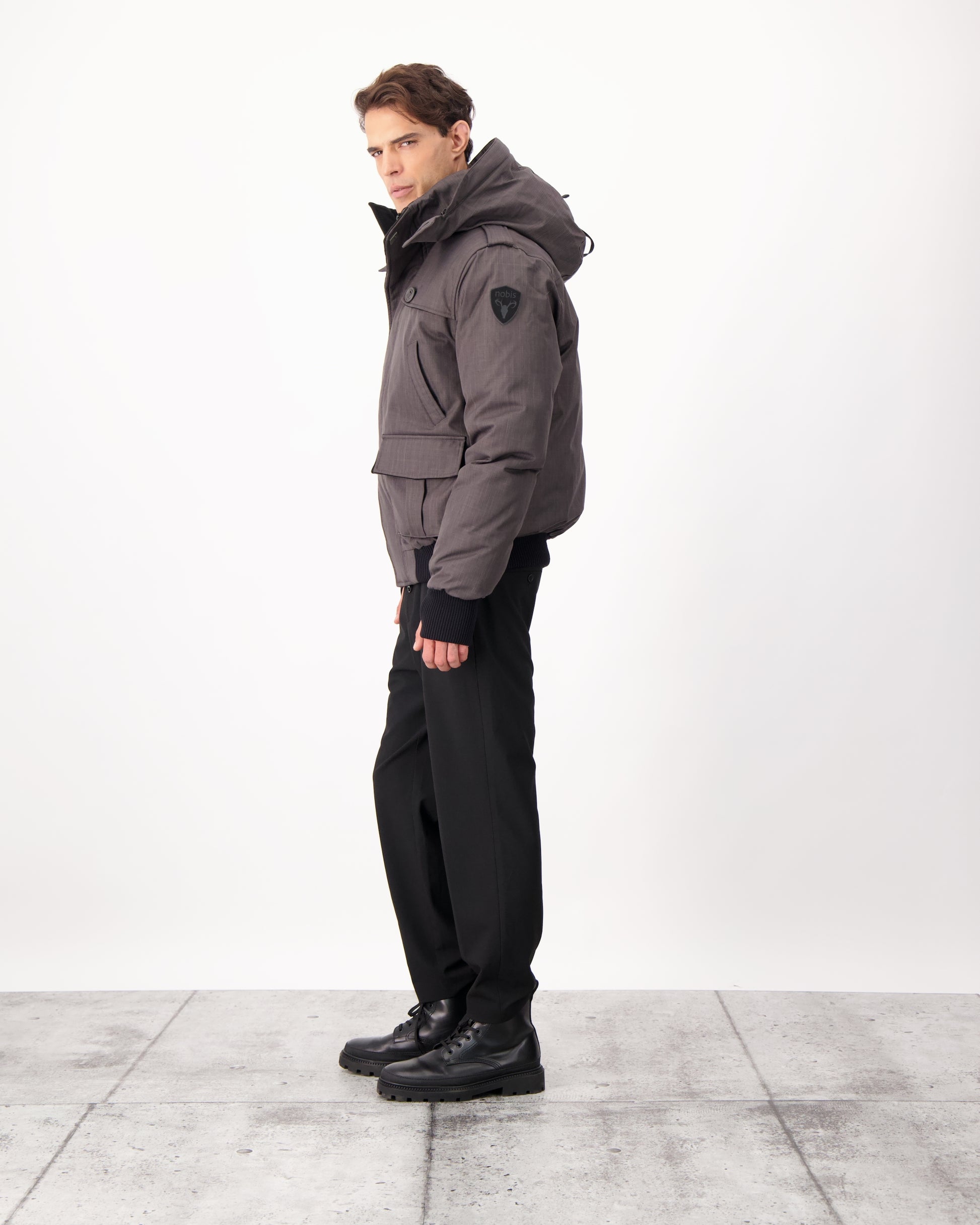 Men's down filled bomber that sits just above the hips with a completely removable hood that's windproof, waterproof, and breathable in CH Steel Grey