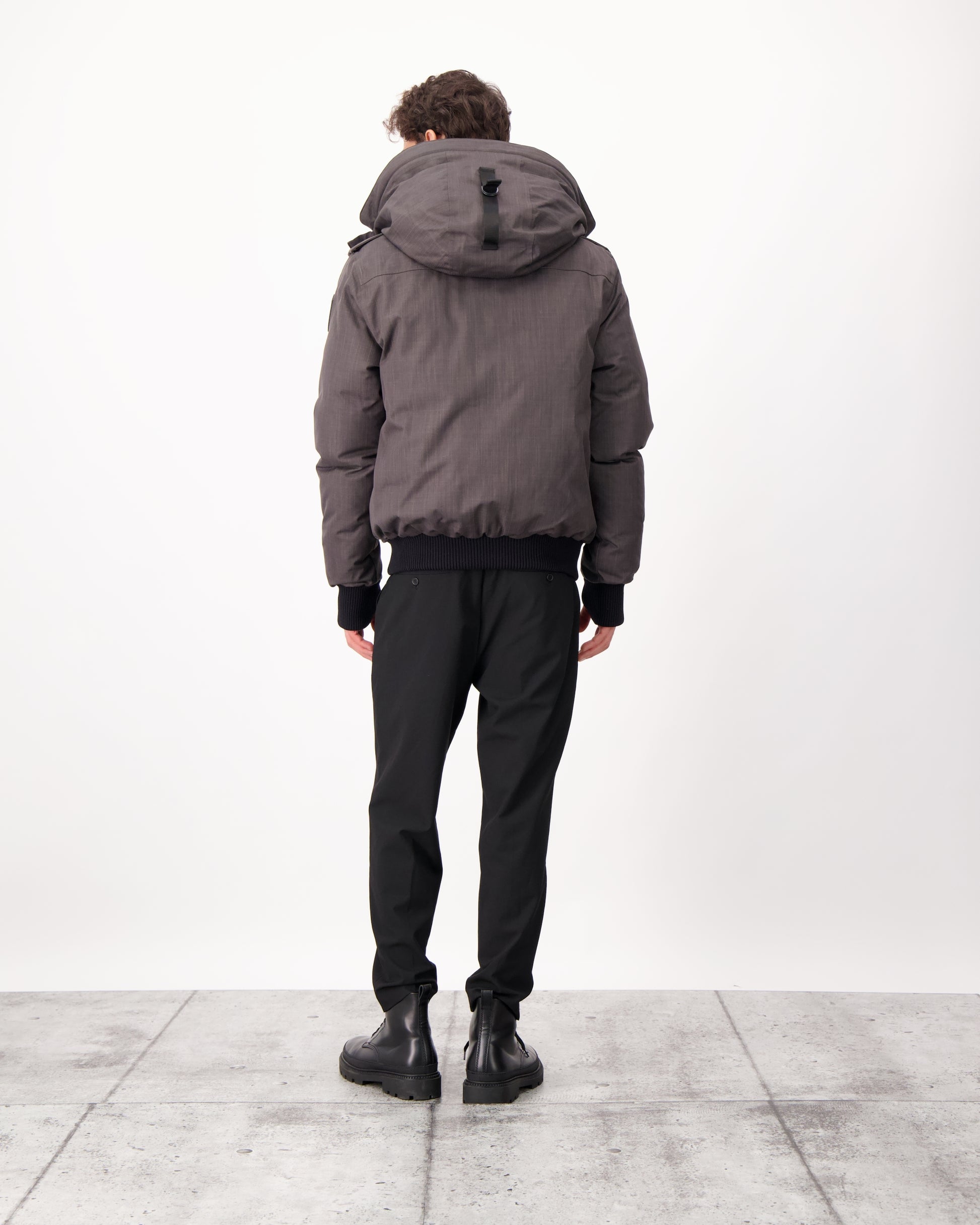 Men's down filled bomber that sits just above the hips with a completely removable hood that's windproof, waterproof, and breathable in CH Steel Grey