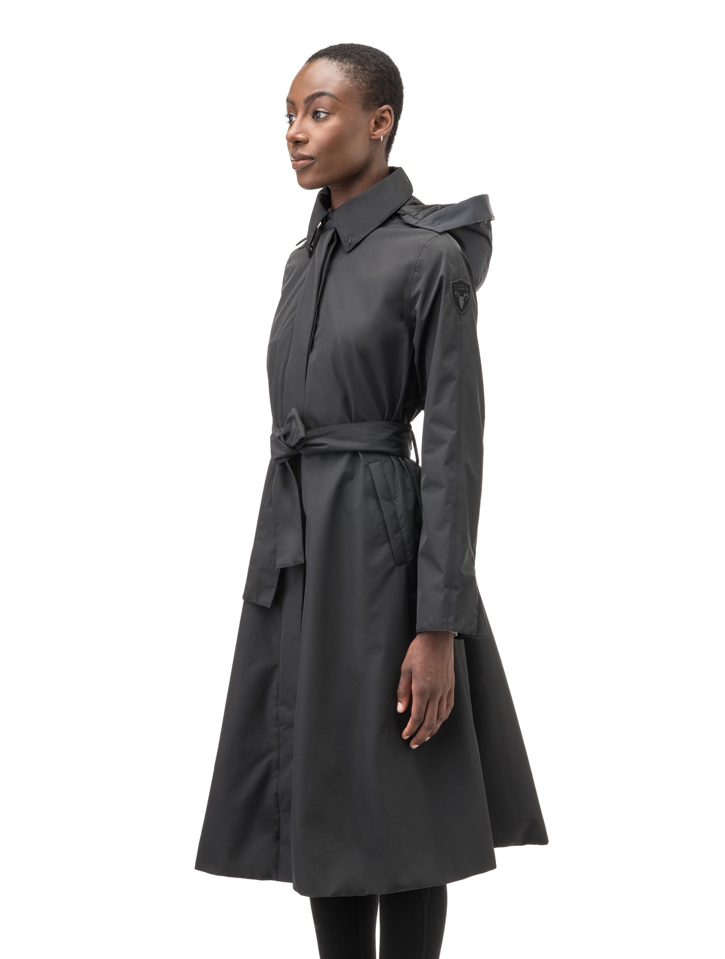 Ivy Ladies Tailored Trench Coat in knee length, 3-Ply Micro Denier fabrication, retractable non-removable hood, front wind flap with snap button closure, removable belt, and adjustable snap cuffs, in Black