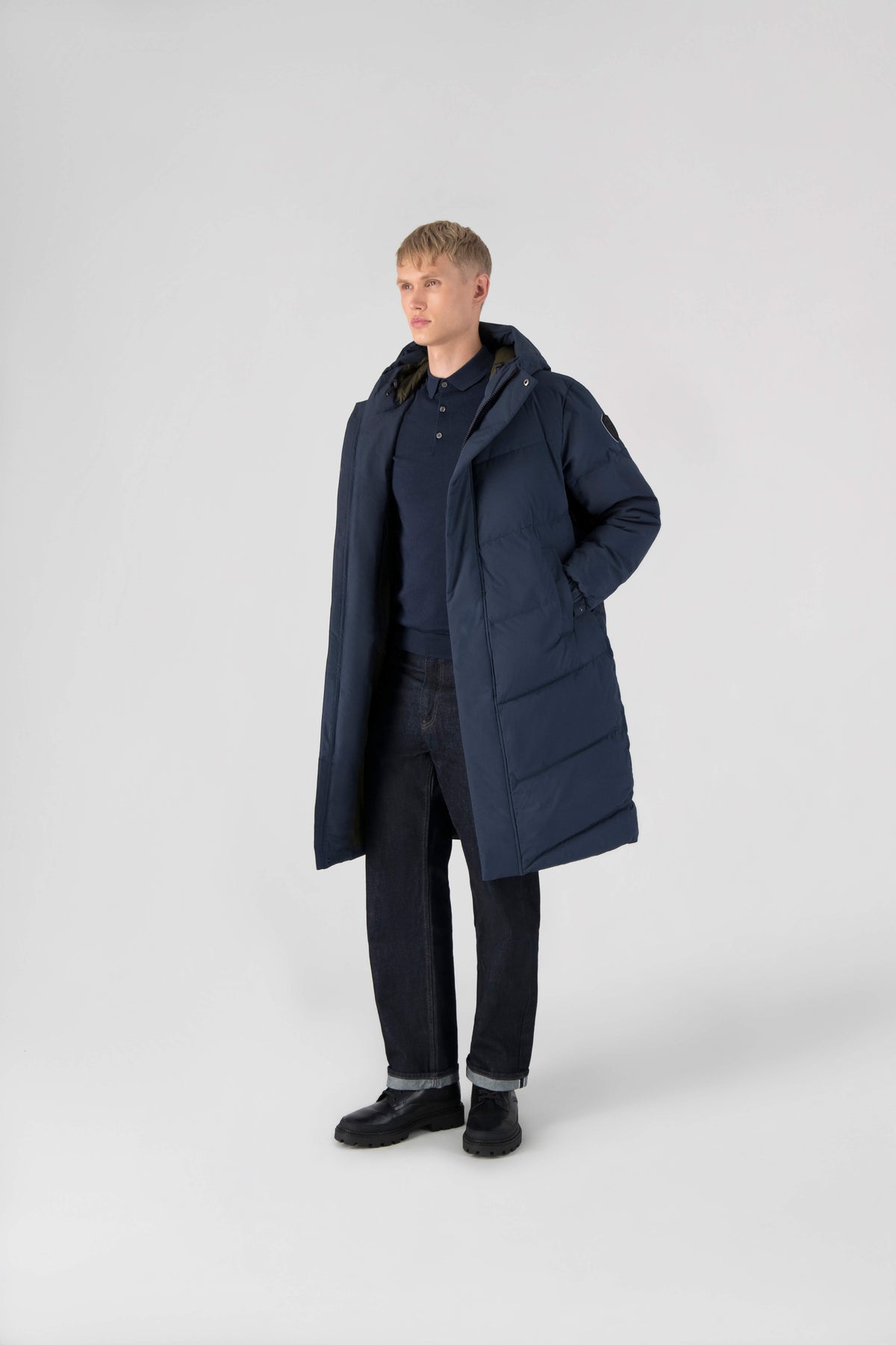 Granger long jacket in Marine stretch ripstop fabric with DWR coating, insulated with Canadian white duck down and Primaloft. Features a two-way zipper, magnetic closure, and adjustable cuffs for warmth and weather protection.