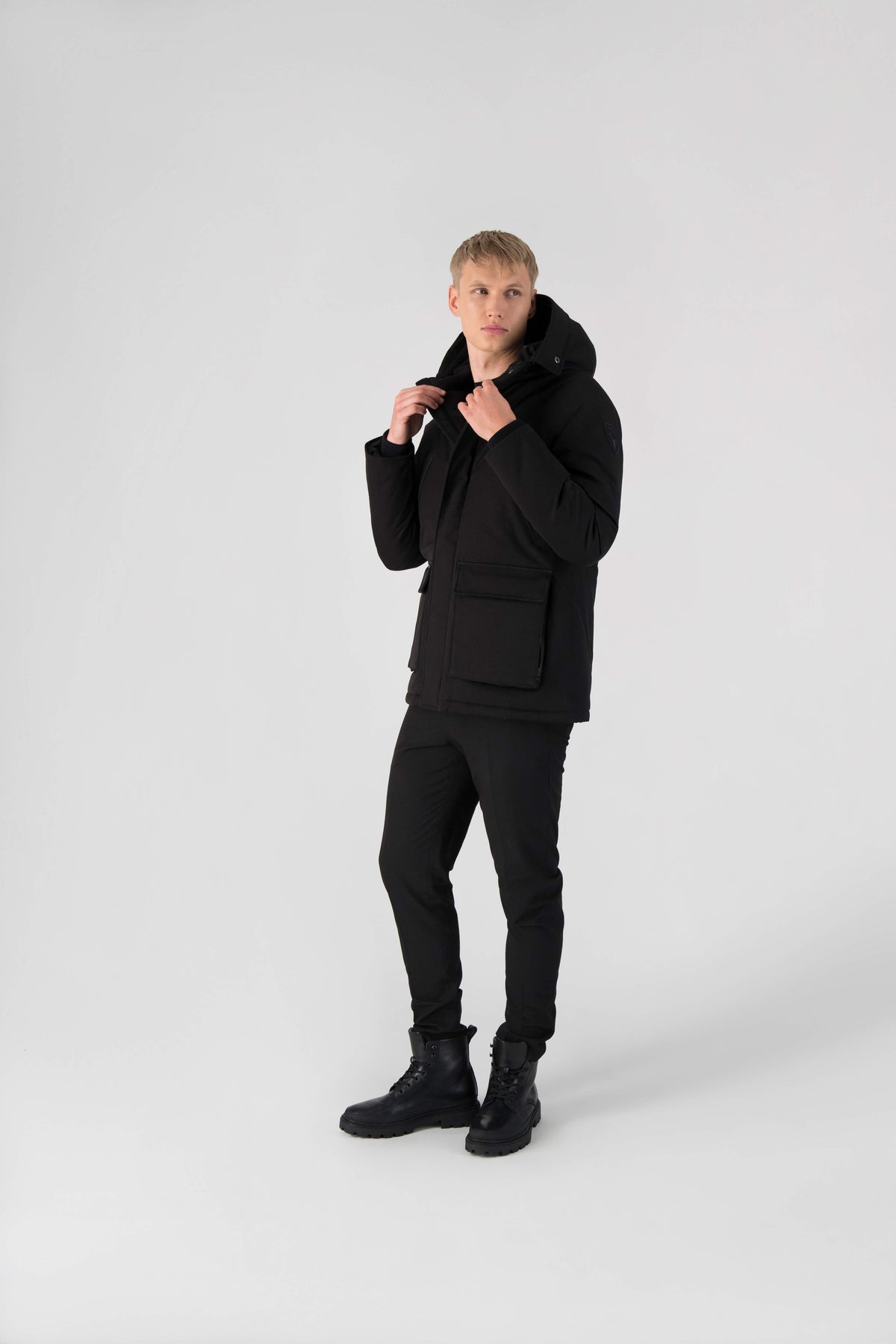 Men's waist length down filled jacket with two front pockets with magnetic closure and a removable fur trim on the hood in Black