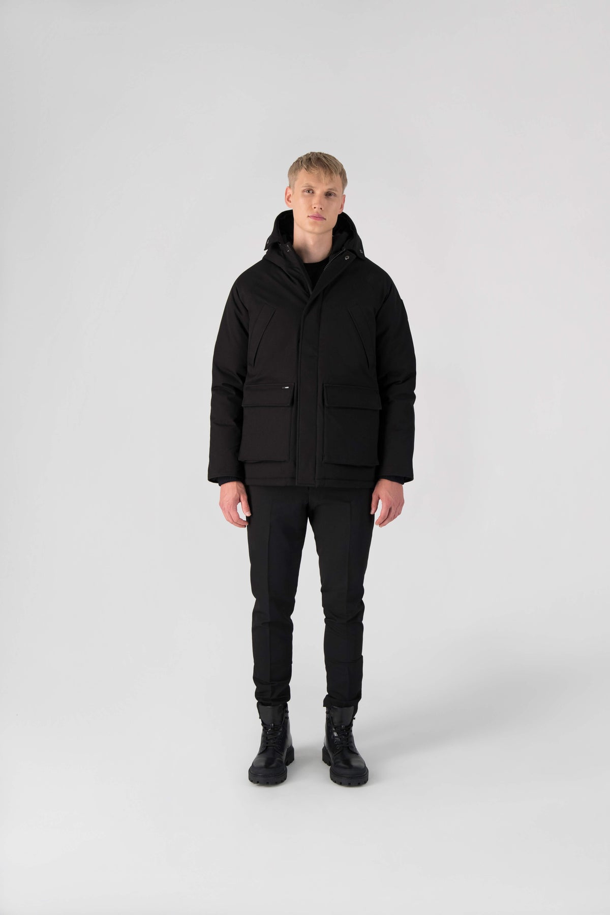 Men's waist length down filled jacket with two front pockets with magnetic closure and a removable fur trim on the hood in Black