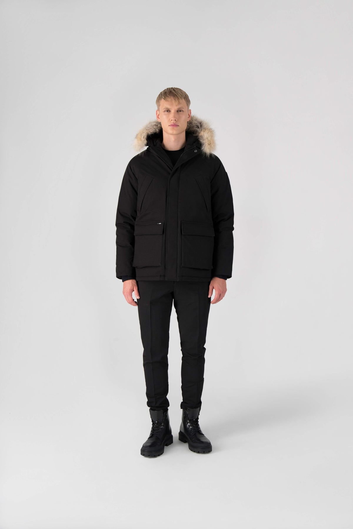 Men's waist length down filled jacket with two front pockets with magnetic closure and a removable fur trim on the hood in Black