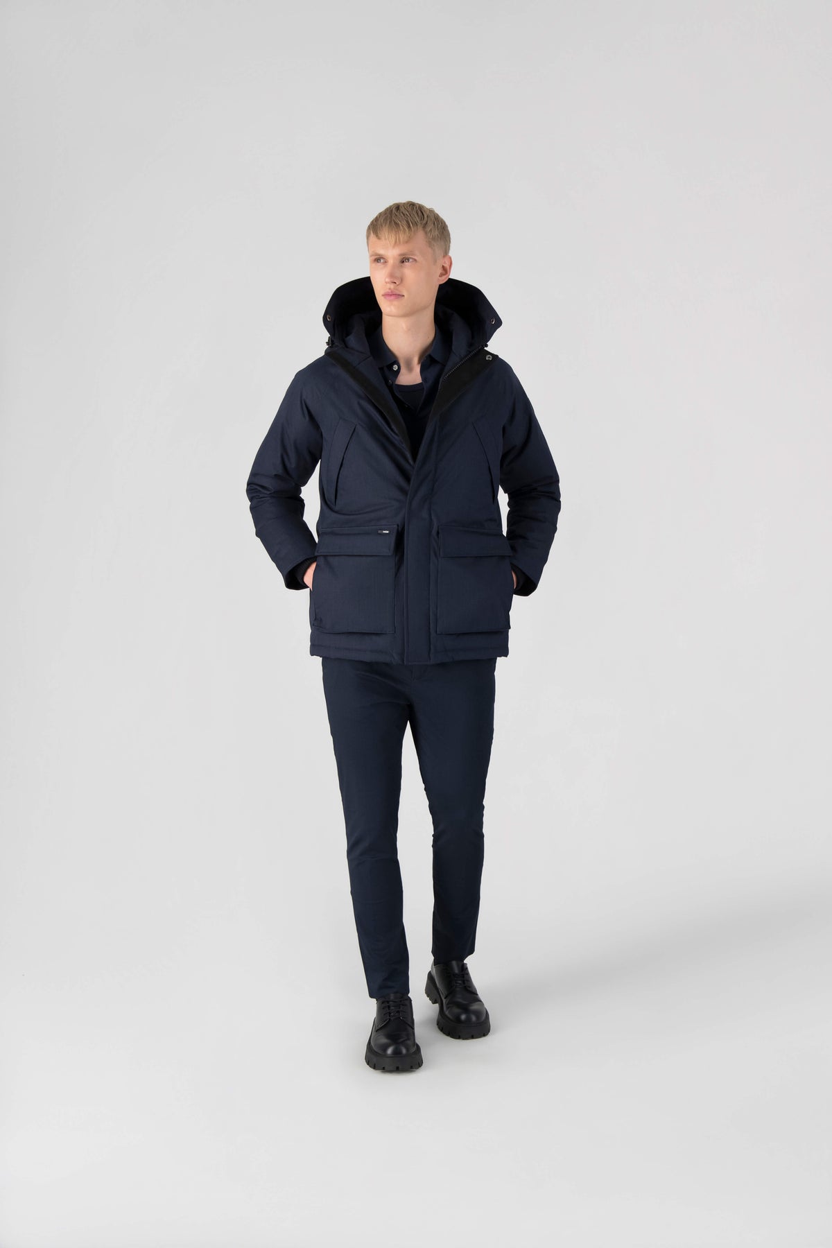 Men's waist length down filled jacket with two front pockets with magnetic closure and a removable fur trim on the hood in Navy