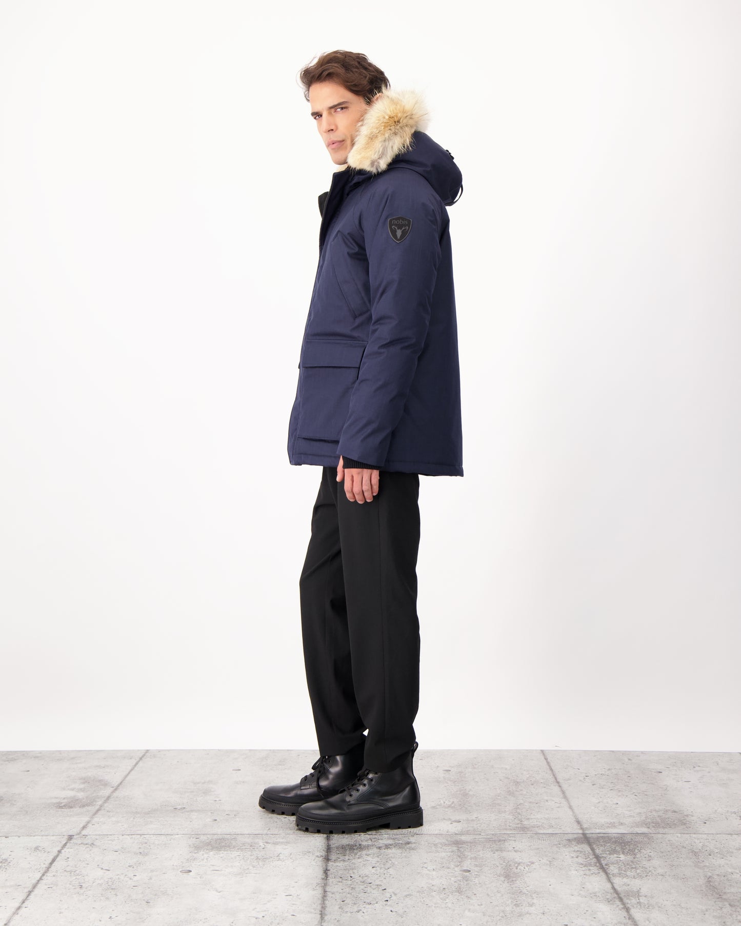 Men's waist length down filled jacket with two front pockets with magnetic closure and a removable fur trim on the hood in CH Navy