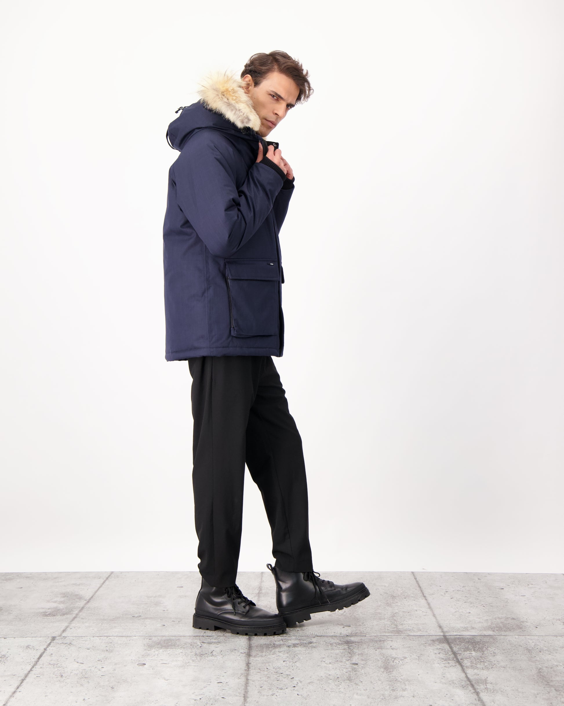 Men's waist length down filled jacket with two front pockets with magnetic closure and a removable fur trim on the hood in CH Navy
