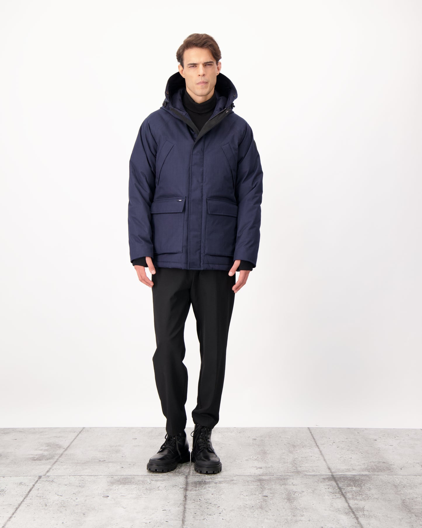 Men's waist length down filled jacket with two front pockets with magnetic closure and a removable fur trim on the hood in CH Navy