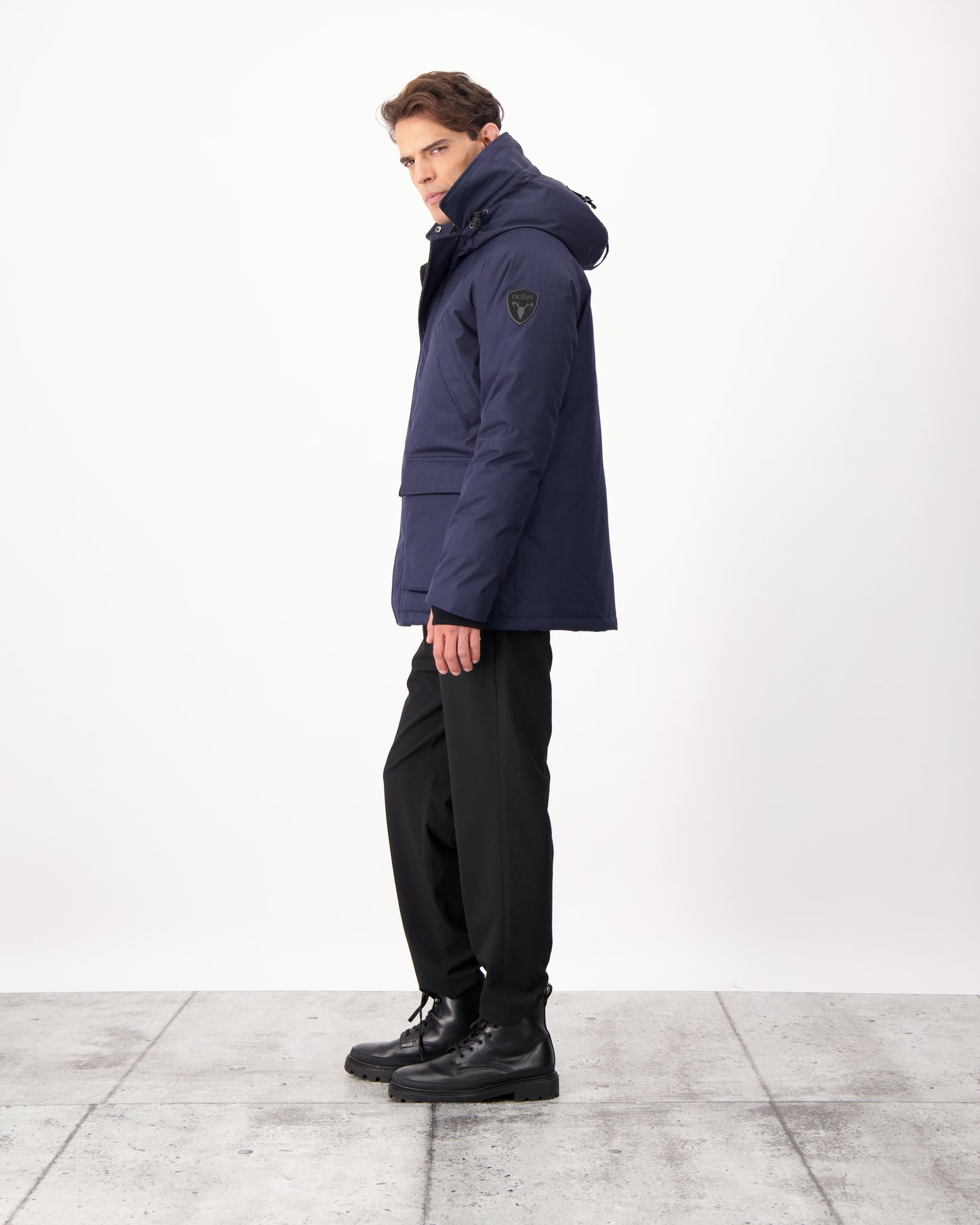 Men's waist length down filled jacket with two front pockets with magnetic closure and a removable fur trim on the hood in CH Navy