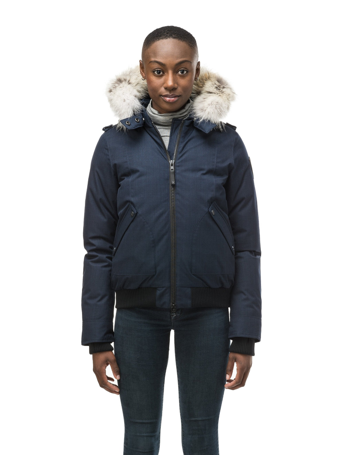 Women's bomber style down filled jacket with a removable hood and fur trim in Navy
