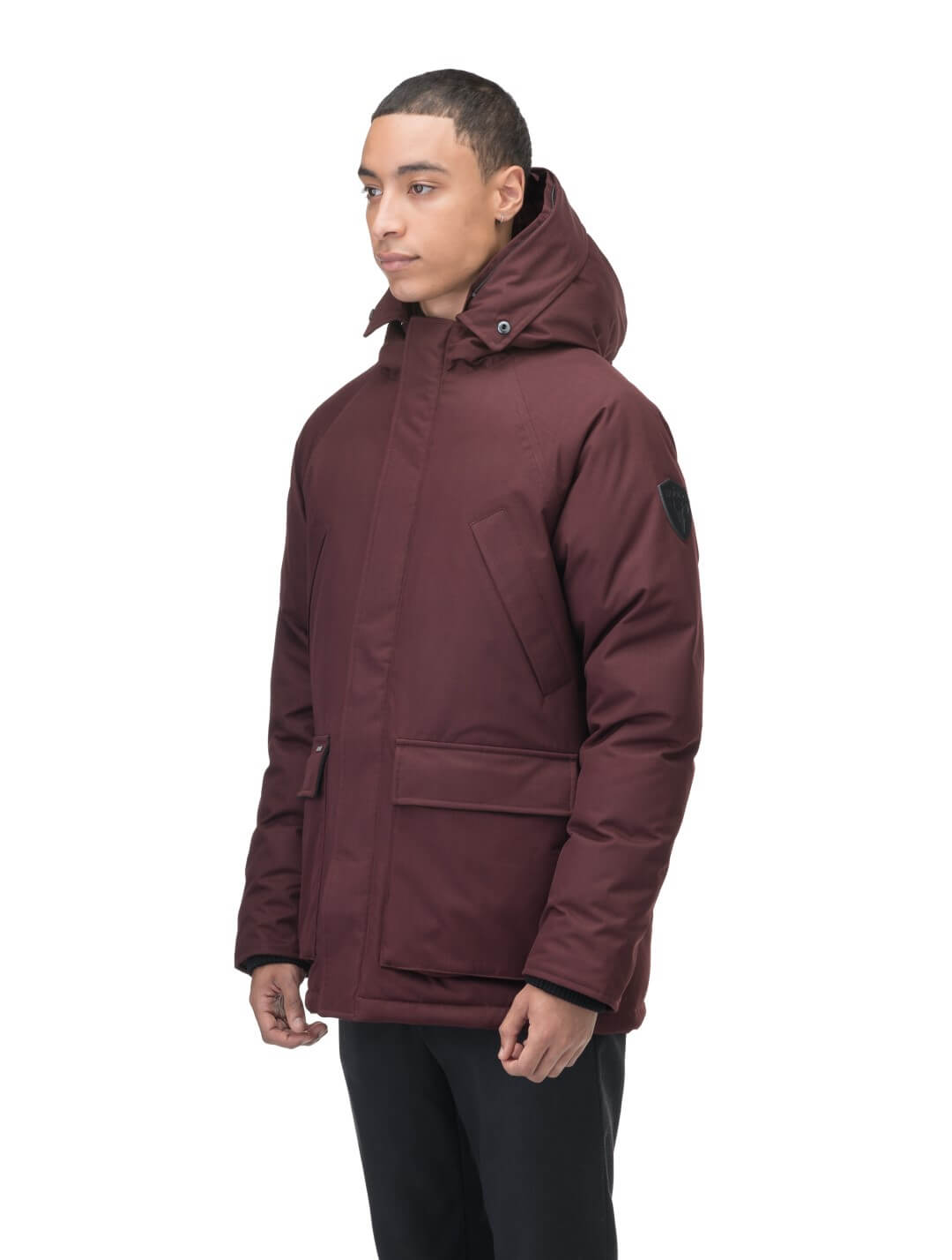 Men's waist length down filled jacket with two front pockets with magnetic closure and a removable fur trim on the hood in Merlot