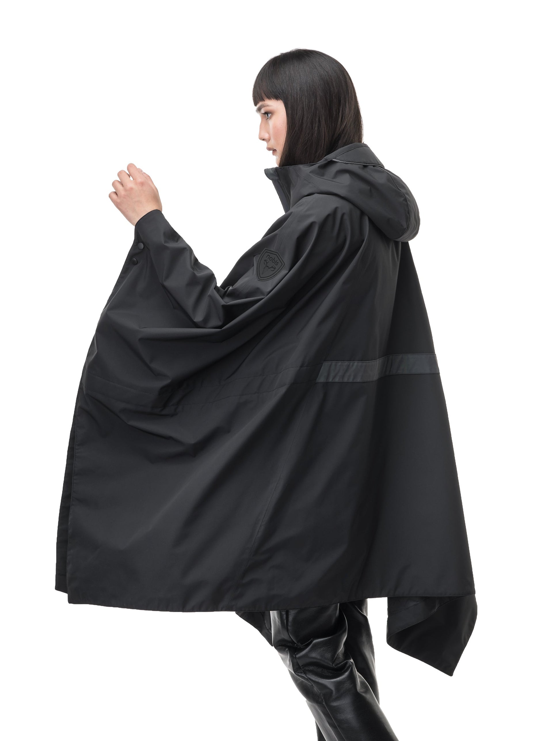 Hydra Unisex Performance Poncho in thigh length, non-removable hood, vertical half-zipper along centre front collar, hidden side-entry waist zipper pockets, adjustable webbing straps and snap closure cuffs, and packable to front kangaroo pocket with flap opening, in Black
