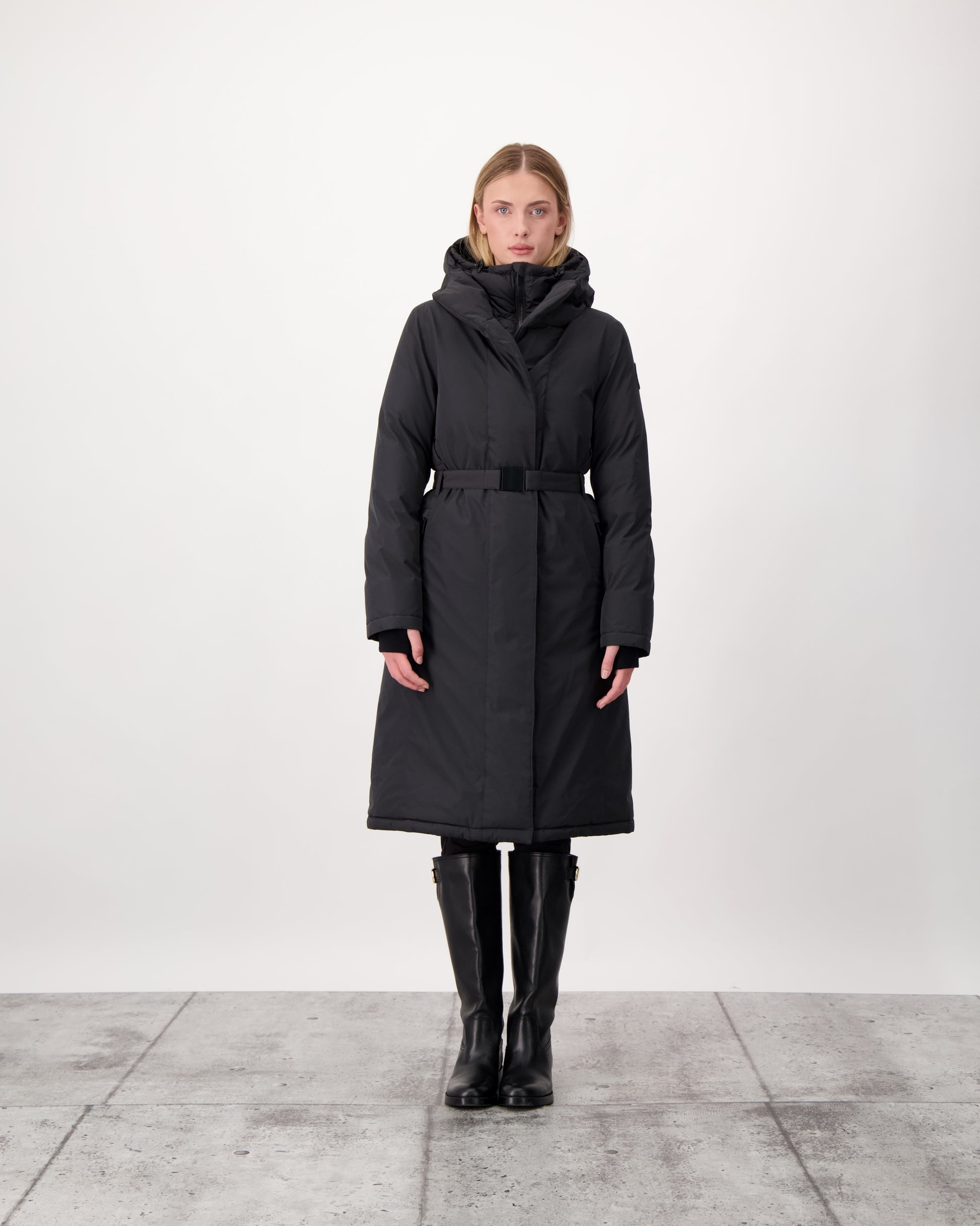 Long calf length hooded women's winter parka with an inner hip length closure, exterior hem length zipper and magnetic placket in Black