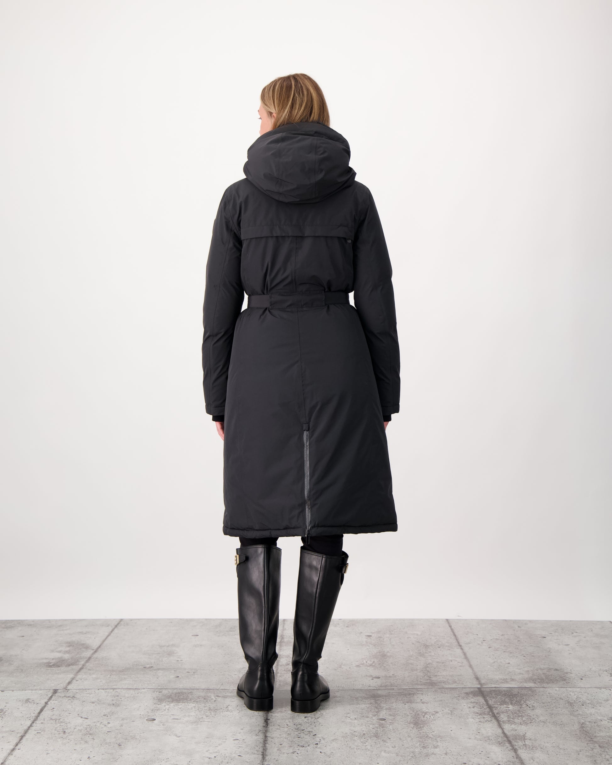 Long calf length hooded women's winter parka with an inner hip length closure, exterior hem length zipper and magnetic placket in Black