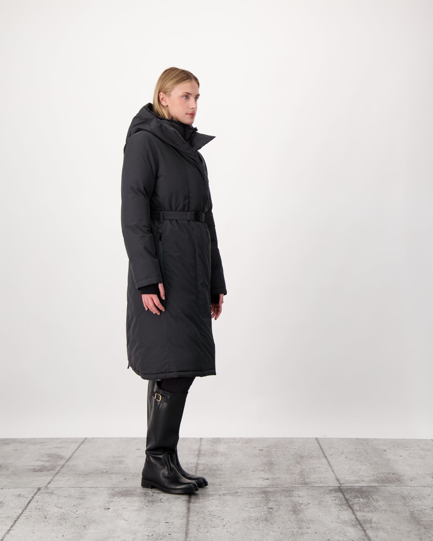 Long calf length hooded women's winter parka with an inner hip length closure, exterior hem length zipper and magnetic placket in Black