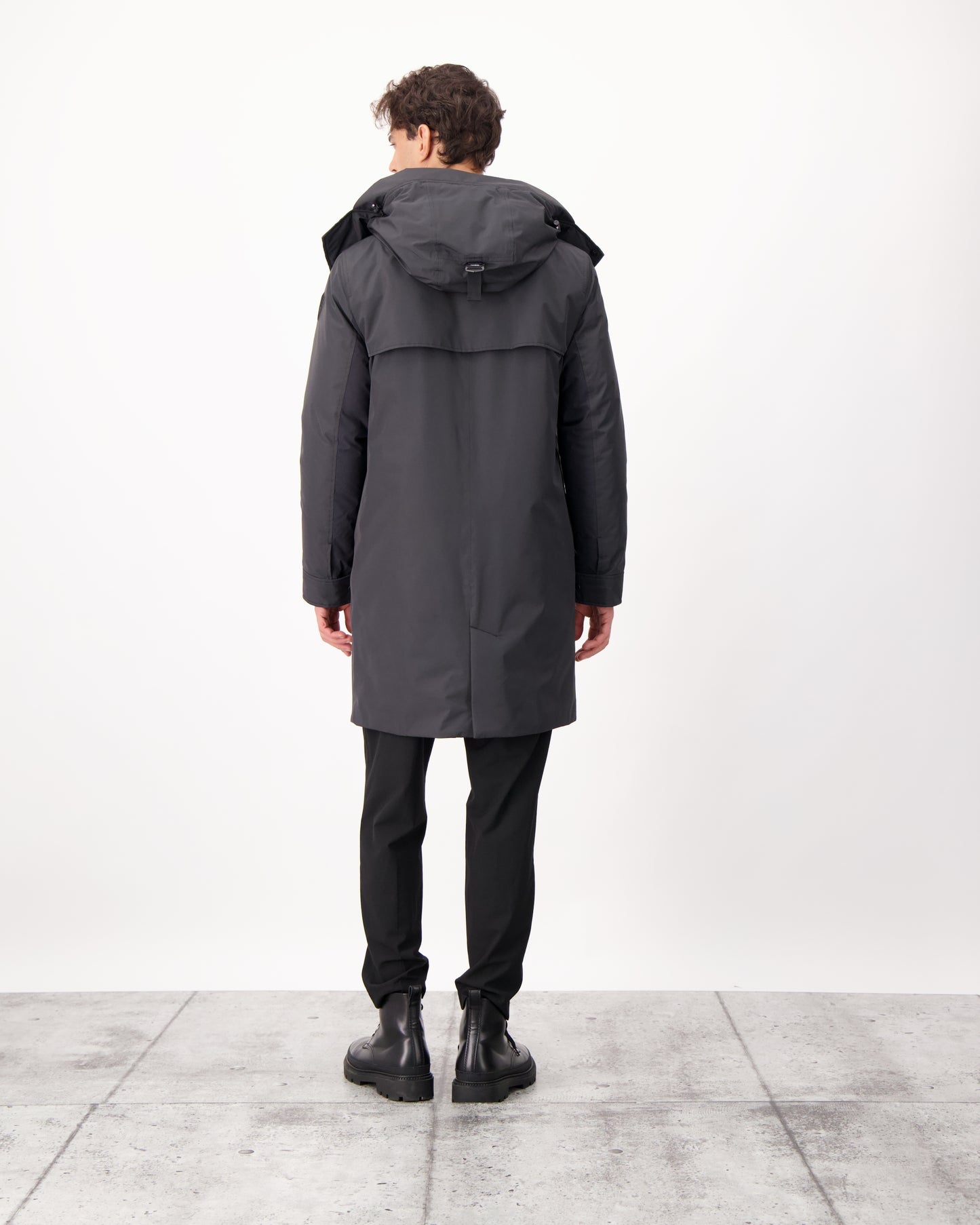 Nord Men's Tailored Trench Coat in knee length, 3-Ply Micro Denier and 4-Way Durable Stretch Weave fabrication, Premium Canadian White Duck Down insulation, removable down-filled hood, exterior zipper pocket at left chest, and adjustable snap button cuffs, in Black