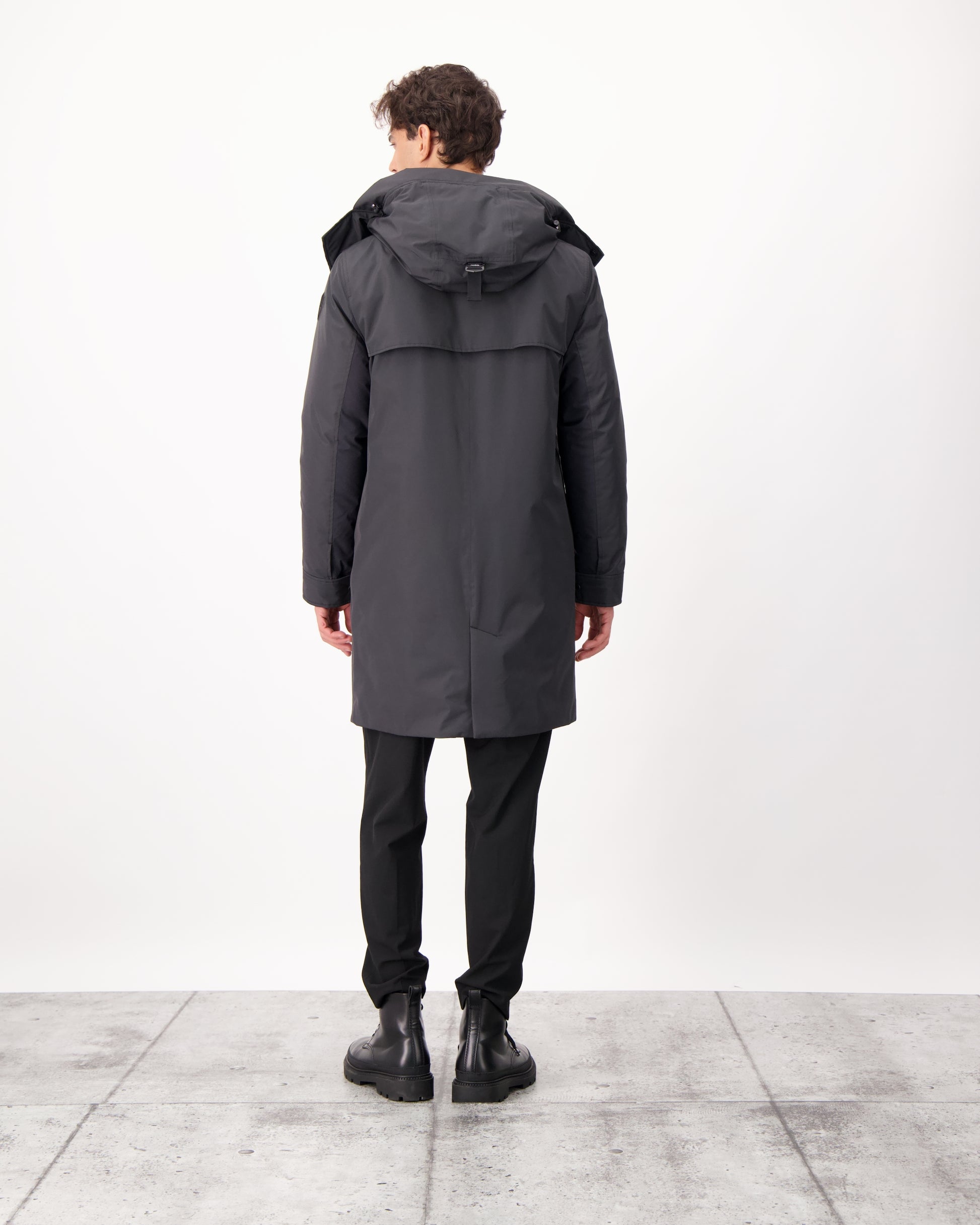 Nord Men's Tailored Trench Coat in knee length, 3-Ply Micro Denier and 4-Way Durable Stretch Weave fabrication, Premium Canadian White Duck Down insulation, removable down-filled hood, exterior zipper pocket at left chest, and adjustable snap button cuffs, in Black