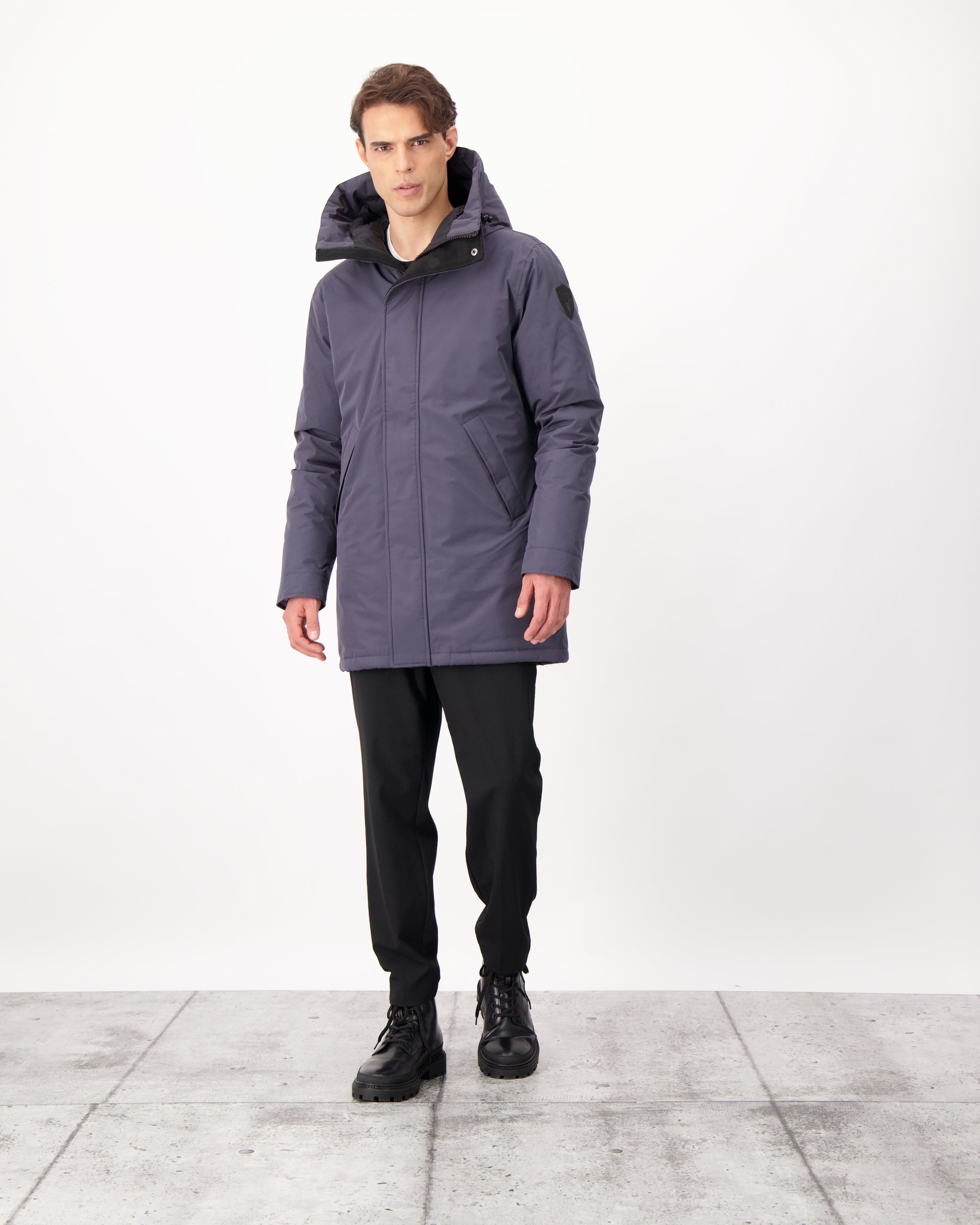 Pierre Men's Jacket in thigh length, Canadian white duck down insulation, non-removable down-filled hood, angled waist pockets, centre-front zipper with wind flap, and elastic ribbed cuffs, in 3L Navy