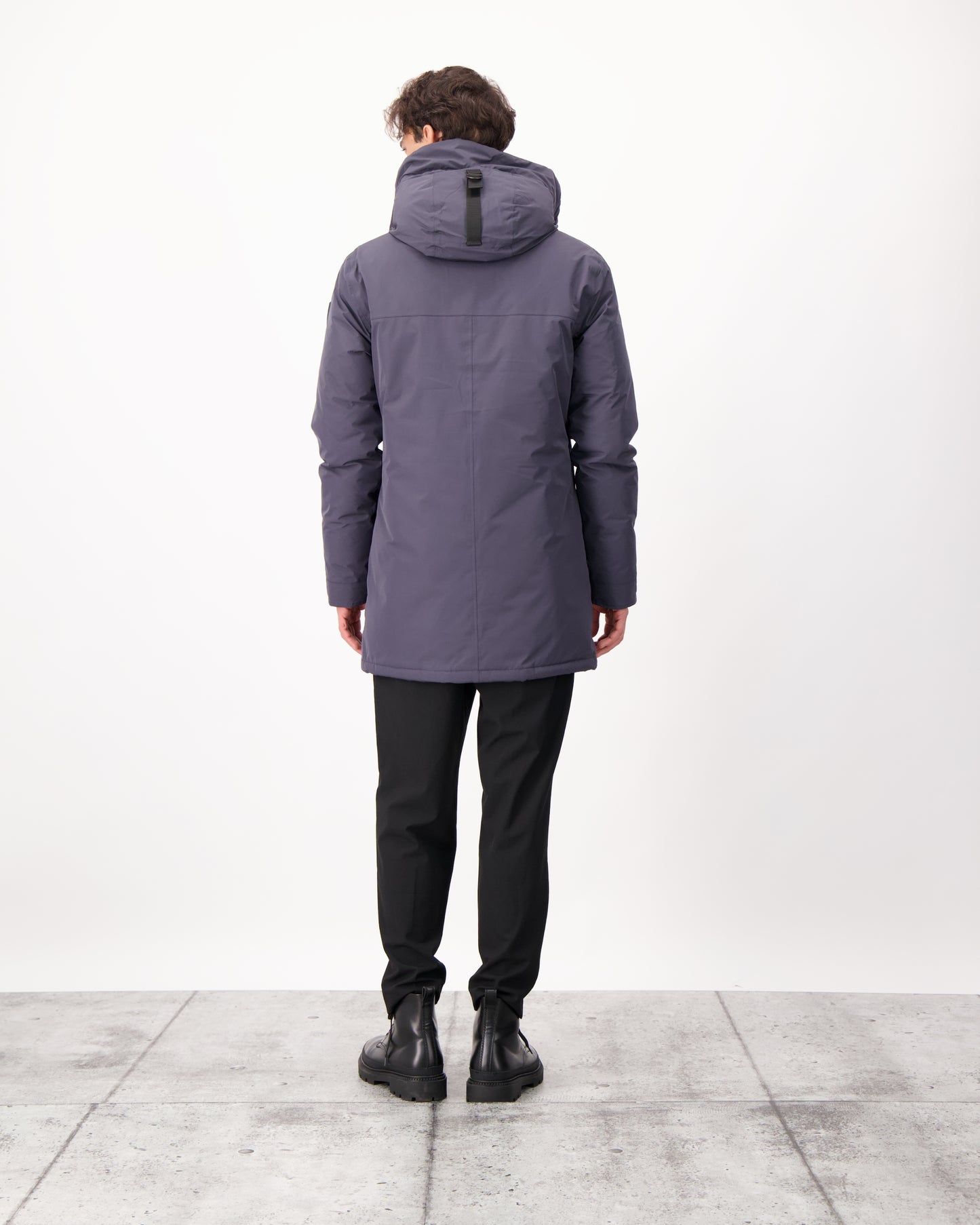 Pierre Men's Jacket in thigh length, Canadian white duck down insulation, non-removable down-filled hood, angled waist pockets, centre-front zipper with wind flap, and elastic ribbed cuffs, in 3L Navy