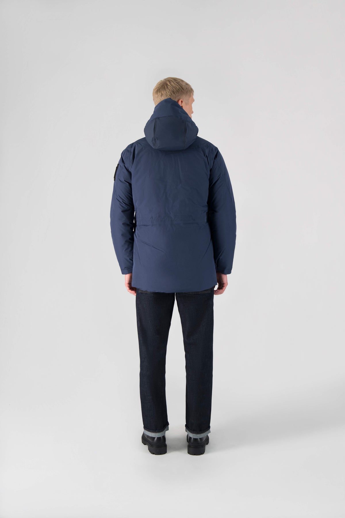 Ronin Men's Performance Utility Jacket in thigh length, premium 3-ply micro denier and stretch ripstop fabrication, Premium Canadian origin White Duck Down insulation, non-removable down-filled hood, bellow chest pockets, magnetic closure waist flap pockets, two-way centre-front zipper, pit zipper vents, hidden adjustable waist drawcord, in Marine