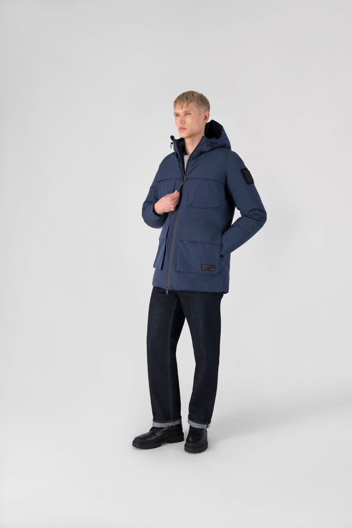 Ronin Men's Performance Utility Jacket in thigh length, premium 3-ply micro denier and stretch ripstop fabrication, Premium Canadian origin White Duck Down insulation, non-removable down-filled hood, bellow chest pockets, magnetic closure waist flap pockets, two-way centre-front zipper, pit zipper vents, hidden adjustable waist drawcord, in Marine