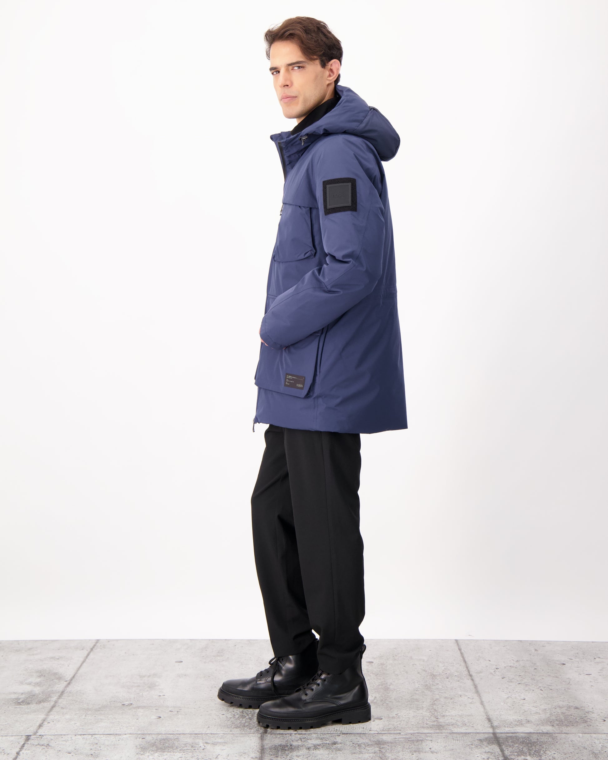 Ronin Men's Performance Utility Jacket in thigh length, premium 3-ply micro denier and stretch ripstop fabrication, Premium Canadian origin White Duck Down insulation, non-removable down-filled hood, bellow chest pockets, magnetic closure waist flap pockets, two-way centre-front zipper, pit zipper vents, hidden adjustable waist drawcord, in Marine