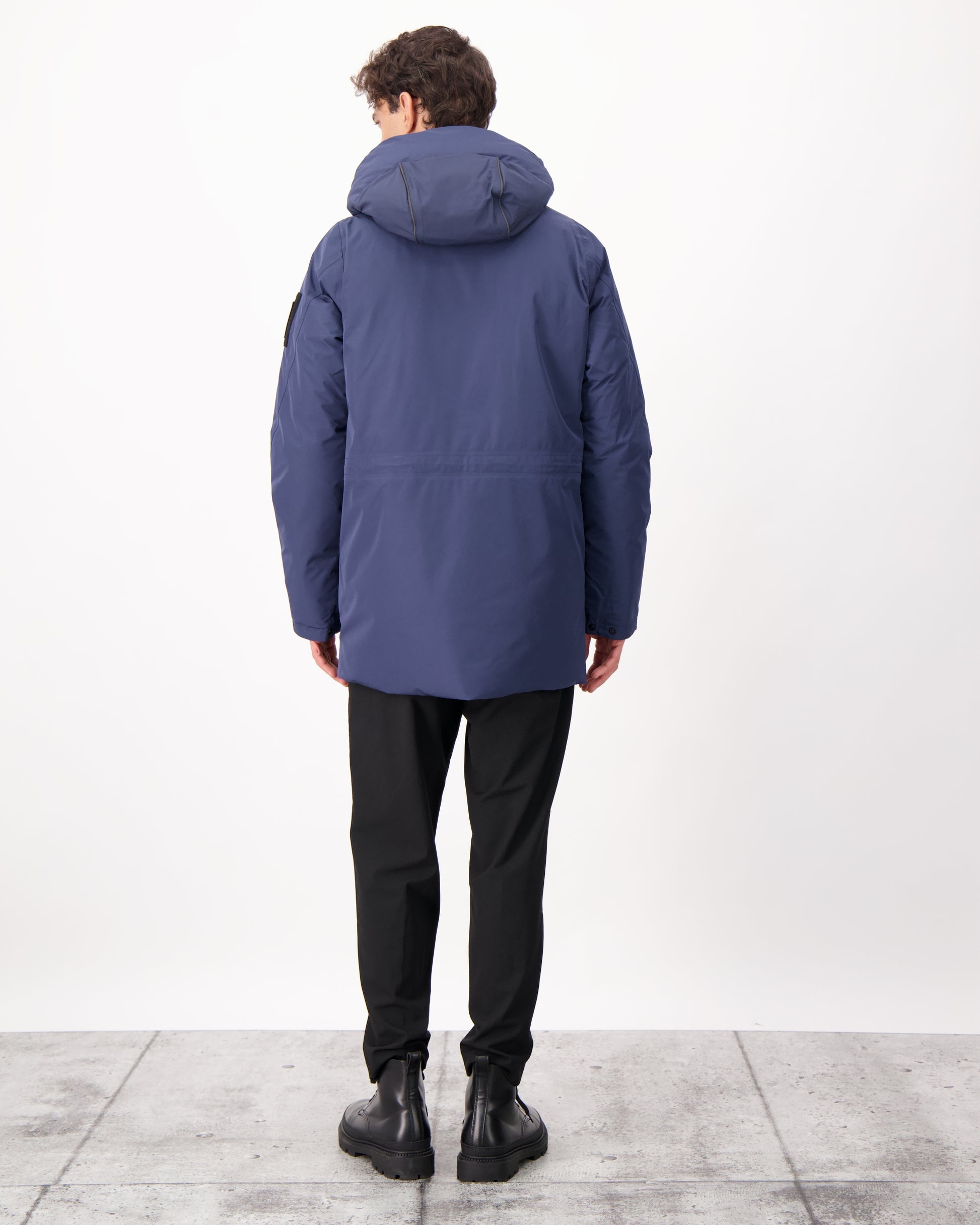 Ronin Men's Performance Utility Jacket in thigh length, premium 3-ply micro denier and stretch ripstop fabrication, Premium Canadian origin White Duck Down insulation, non-removable down-filled hood, bellow chest pockets, magnetic closure waist flap pockets, two-way centre-front zipper, pit zipper vents, hidden adjustable waist drawcord, in Marine